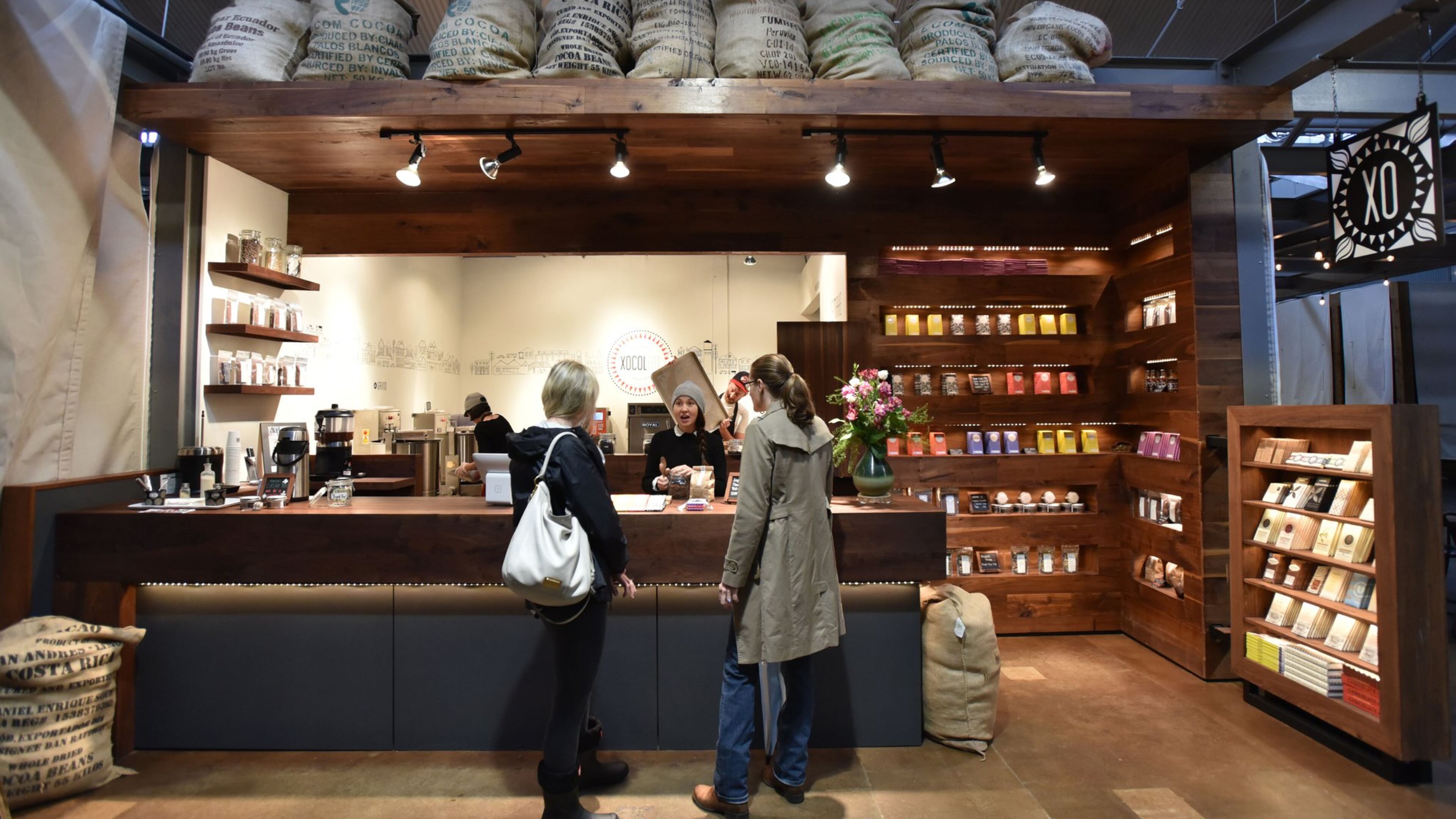 February 3, 2016 Atlanta - Caitlin Higgins (center) helps customers at Xocolatl Small Batch Chocolate in Krog Street Market on Wednesday, February 3, 2016. The owners of Xocolatl, Elaine Read and Matt Weyandt, make bean-to-bar chocolate in their micro-factory at Krog Street Market in Atlanta.