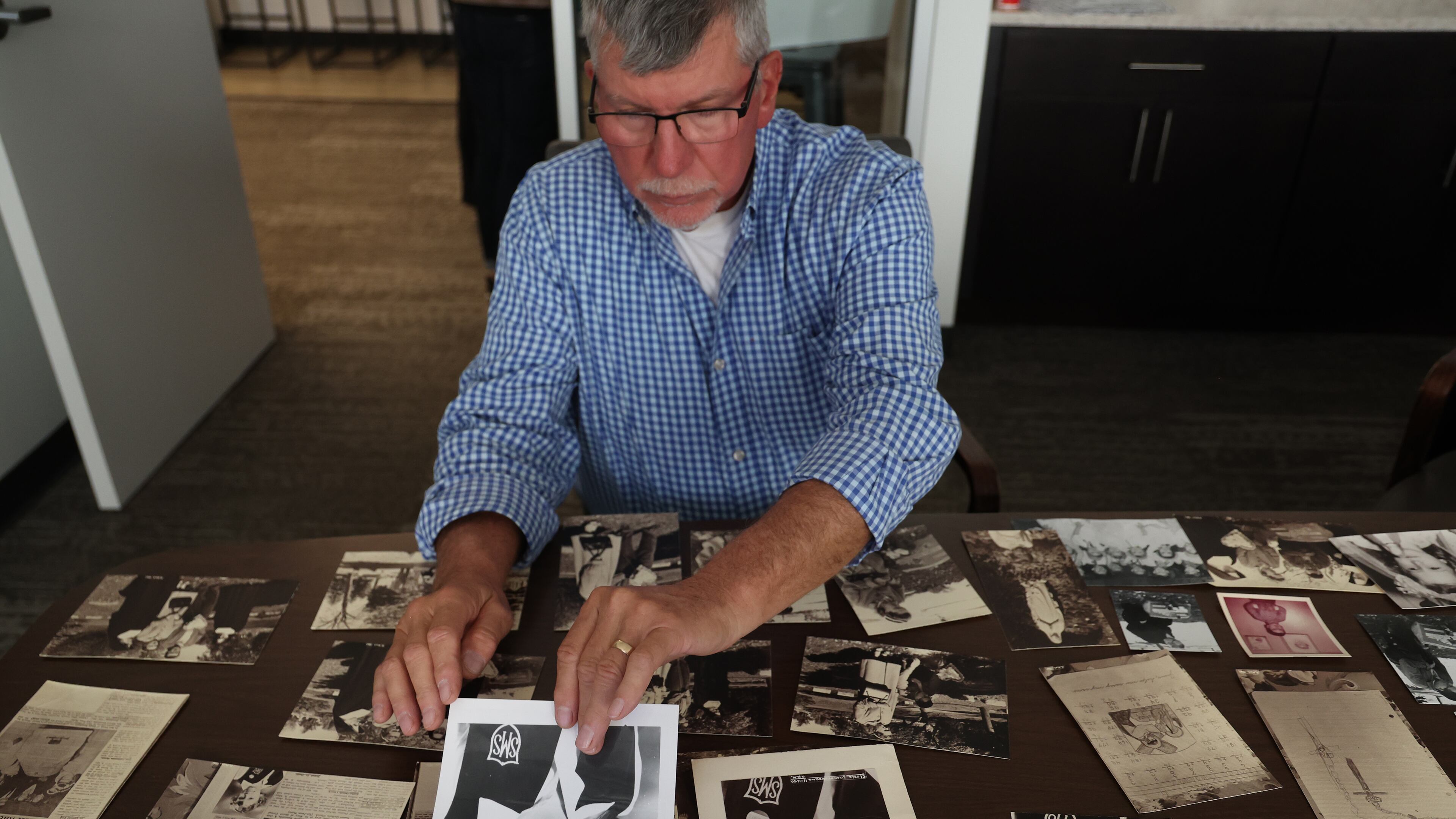 FILE - Adam Kowalewicz holds a photo of his slain sister, Gloria, as he displays family photos during an interview with the Chicago Tribune on Oct. 9, 2026. (Antonio Perez /Chicago Tribune via AP)