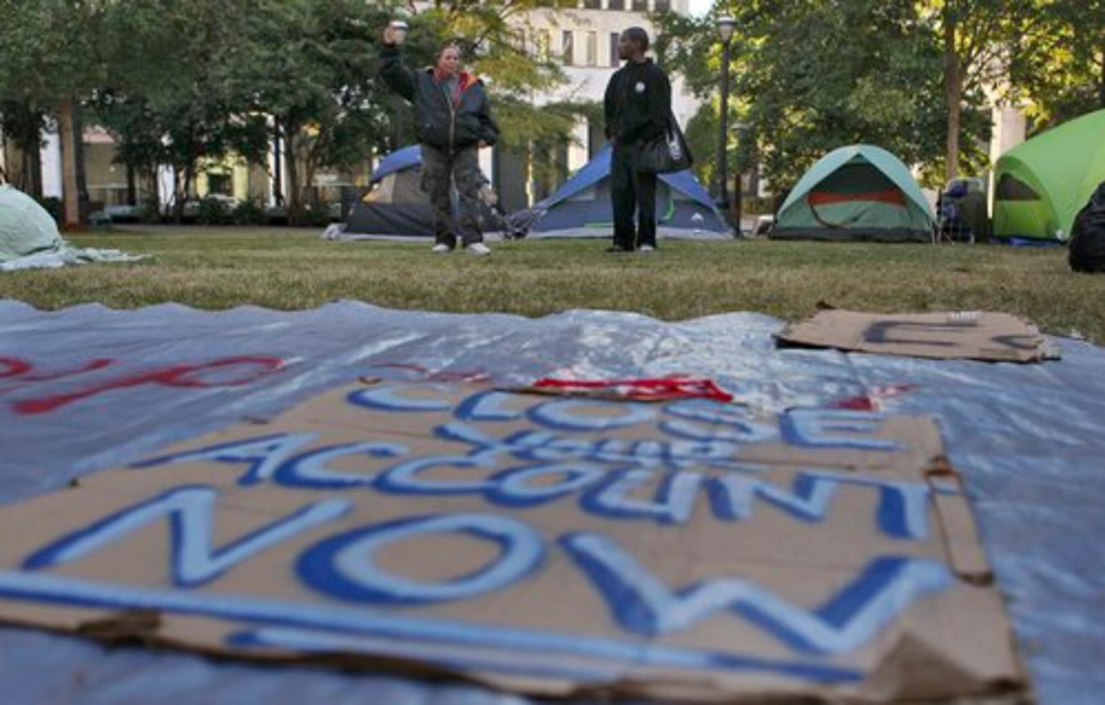 Activists walk around Woodruff Park on Monday.