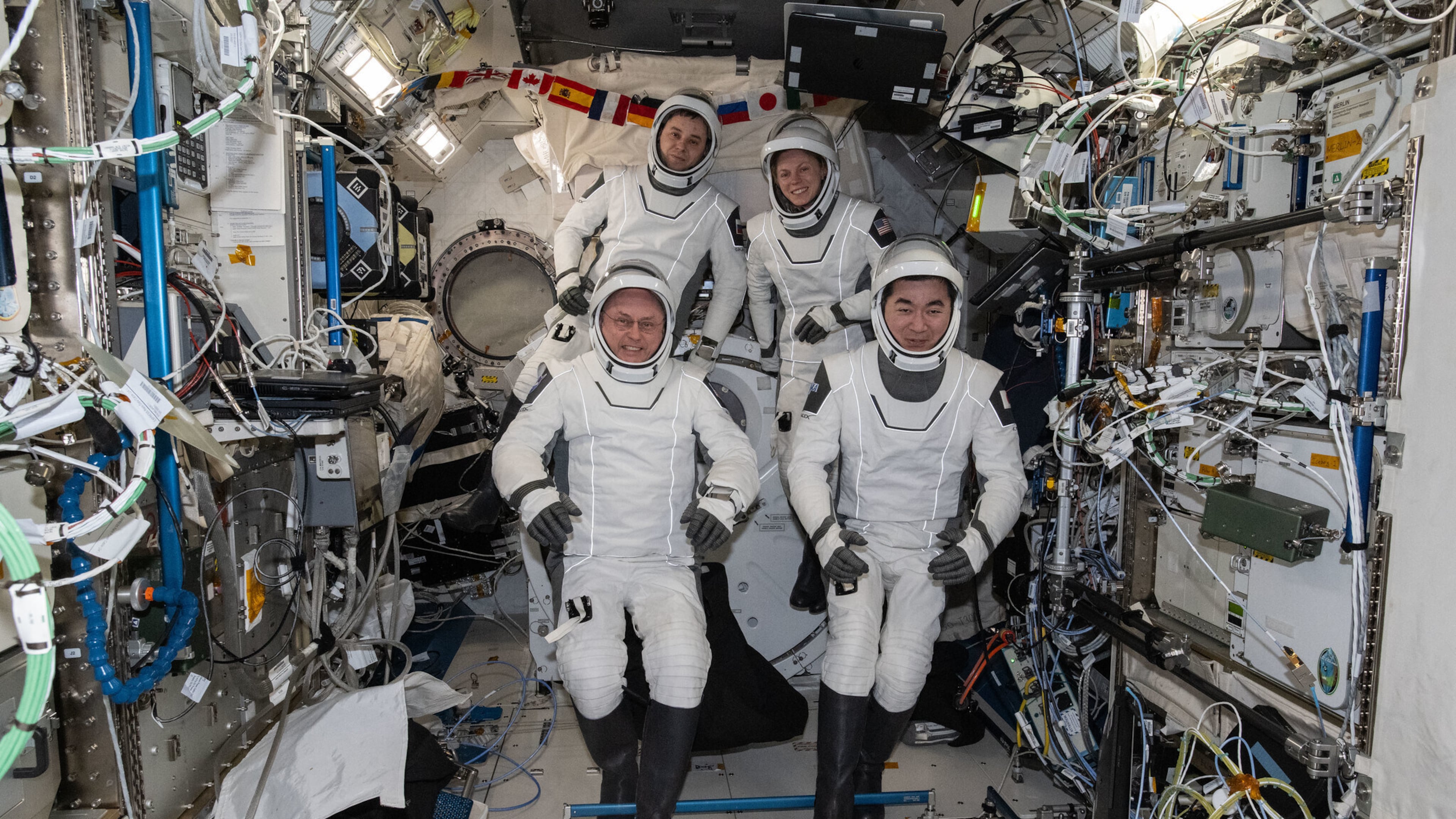 This photo provided by NASA shows clockwise from bottom left are, NASA astronaut Mike Fincke, Roscosmos cosmonaut Oleg Platonov, NASA astronaut Zena Cardman, and JAXA (Japan Aerospace Exploration Agency) astronaut Kimiya Yui gathering for a crew portrait wearing their Dragon pressure suits during a suit verification check inside the International Space Station’s Kibo laboratory module, Wednesday, Jan. 14, 2026. (NASA via AP)