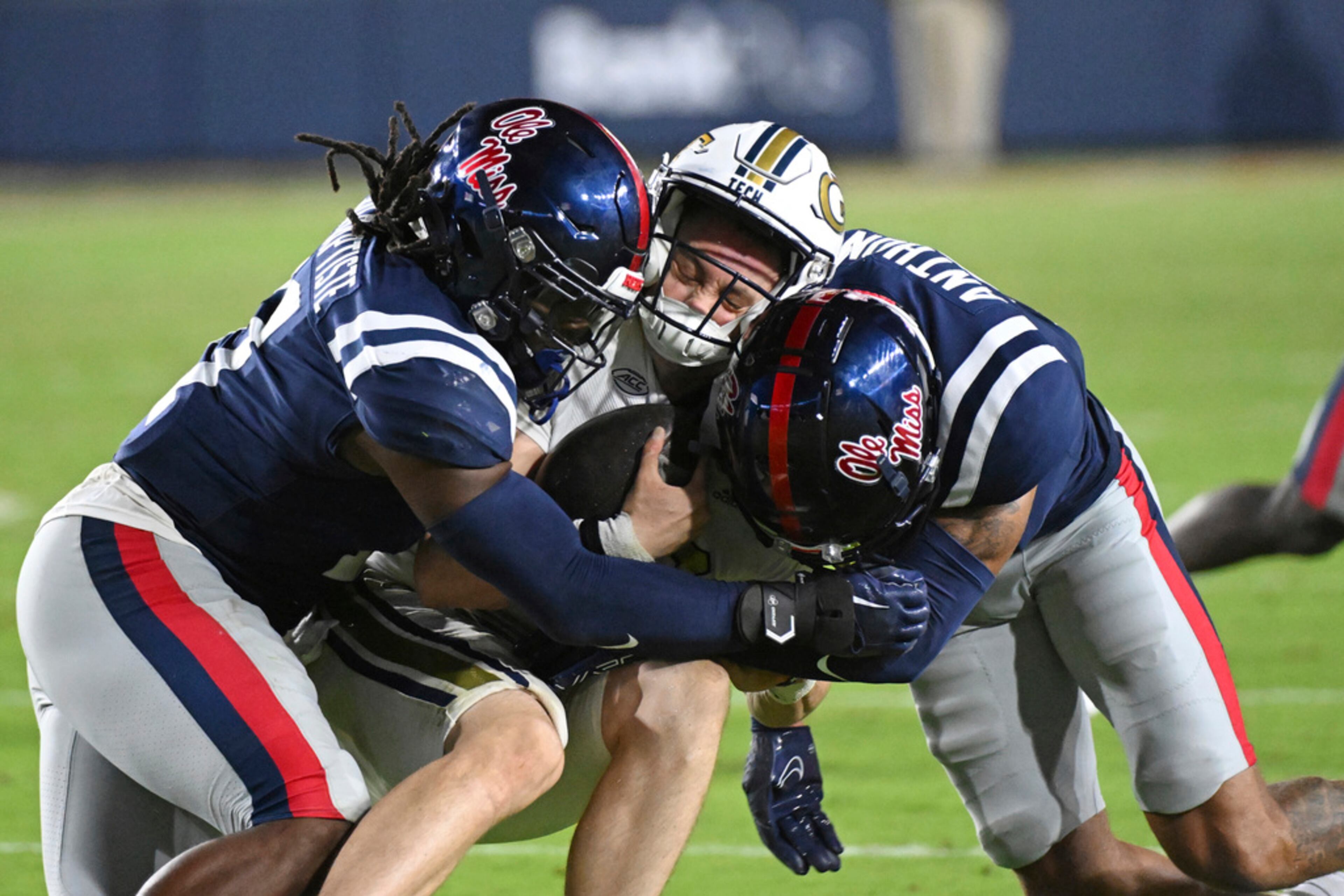 Mississippi linebacker Jeremiah Jean-Baptiste, left, and safety Daijahn Anthony tackle Georgia Tech quarterback Haynes King during the second half an NCAA college football game in Oxford, Miss., Saturday, Sept. 16, 2023. Georgia Tech lost 48-23. (AP Photo/Thomas Graning)