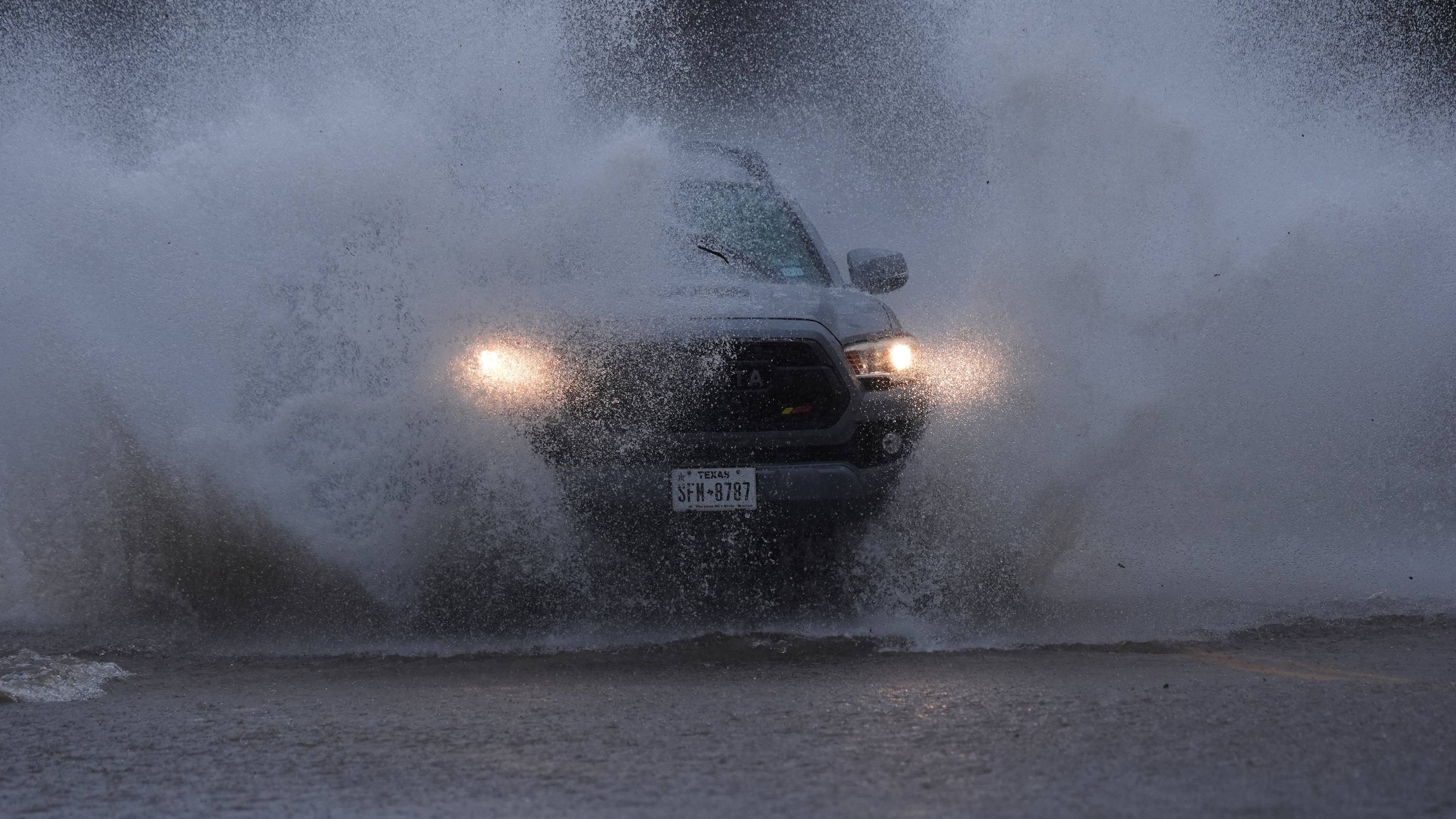 A vehicle navigates a flooded roadway as heavy rain move through the area, in San Antonio, Thursday, Oct. 1, 2026. (AP Photo/Eric Gay)