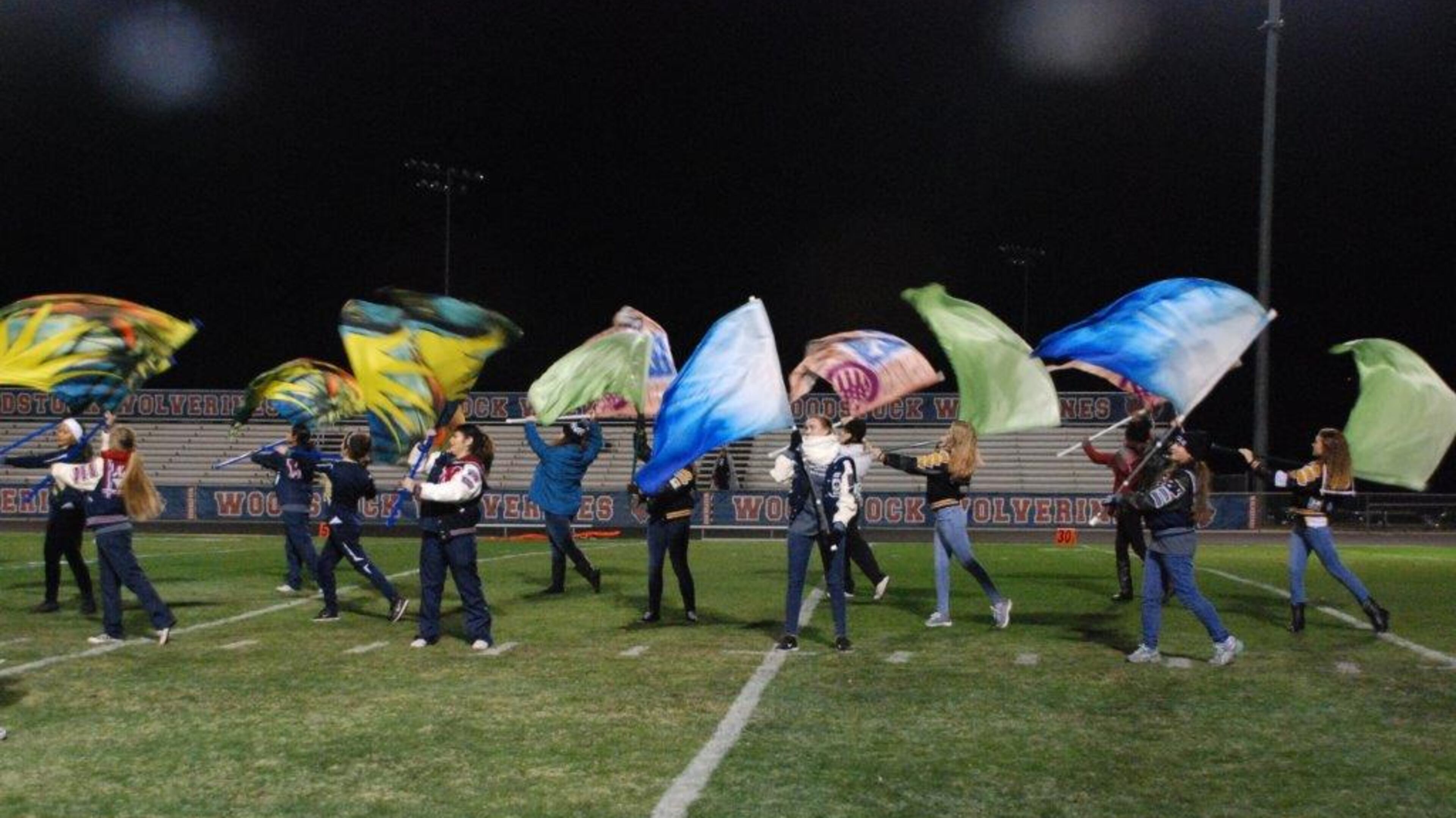 The Senior Bowl Flag Corps performs at Cherokee County schools’ fundraising football game.