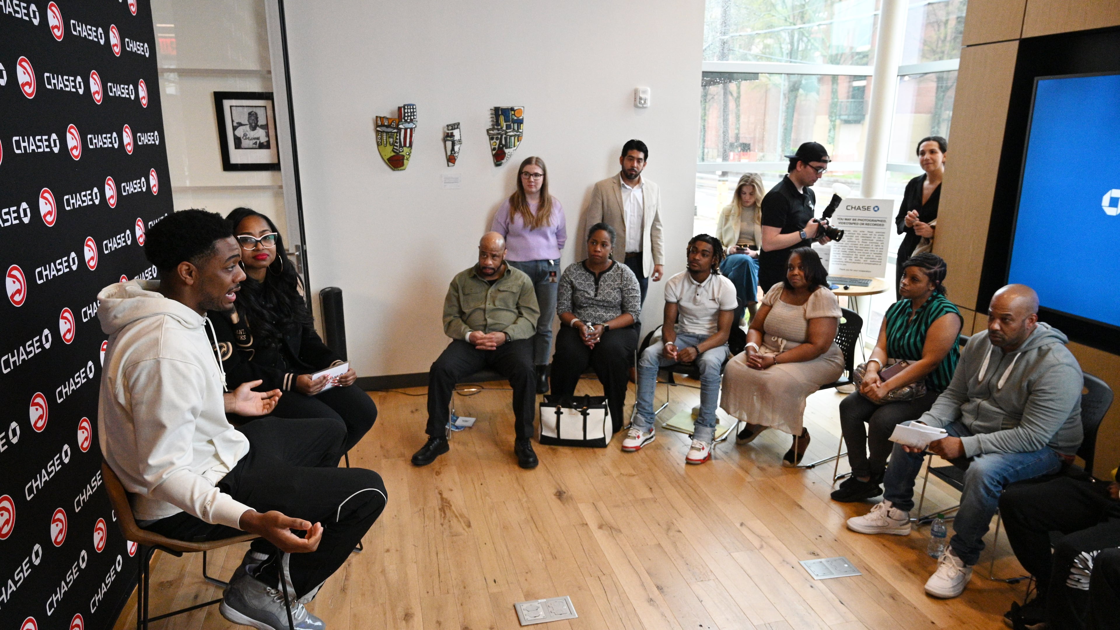 Atlanta Hawks guard Trent Forrest (left) speaks as Alexis Roe (second from left), Atlanta Hawks’ Vice President of DEI Impact and Strategic Initiatives, moderates during educational workshops to enhance their financial health and understanding of business finances at Summerhill Chase Community Center Branch, Tuesday, March 26, 2024, in Atlanta. The Atlanta Hawks and Chase are launching a new community program for aspiring entrepreneurs impacted by the justice system. (Hyosub Shin / Hyosub.Shin@ajc.com)