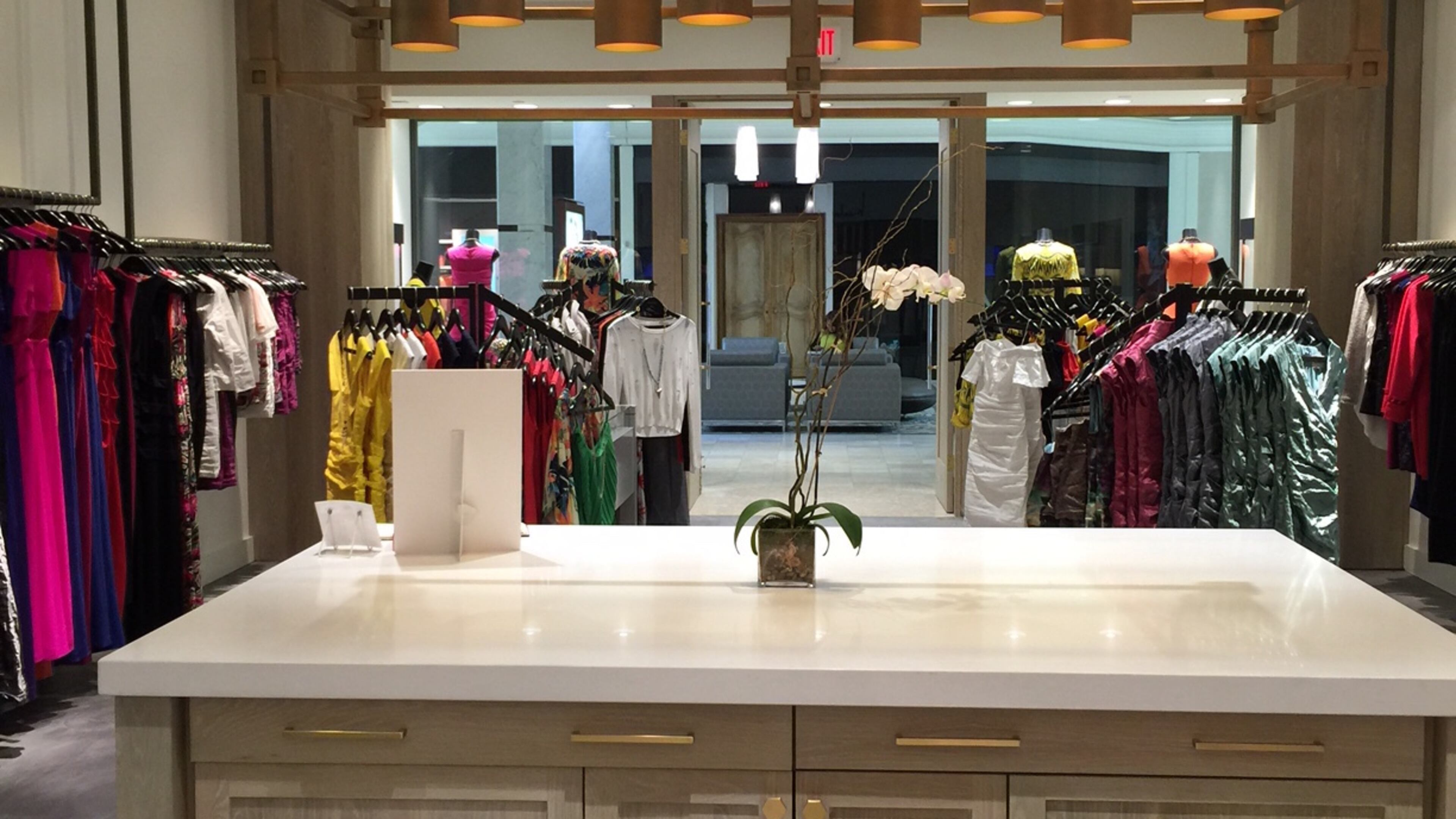 A large island anchors the Nicole Miller boutique at Phipps Plaza creating a warm, casual environment.