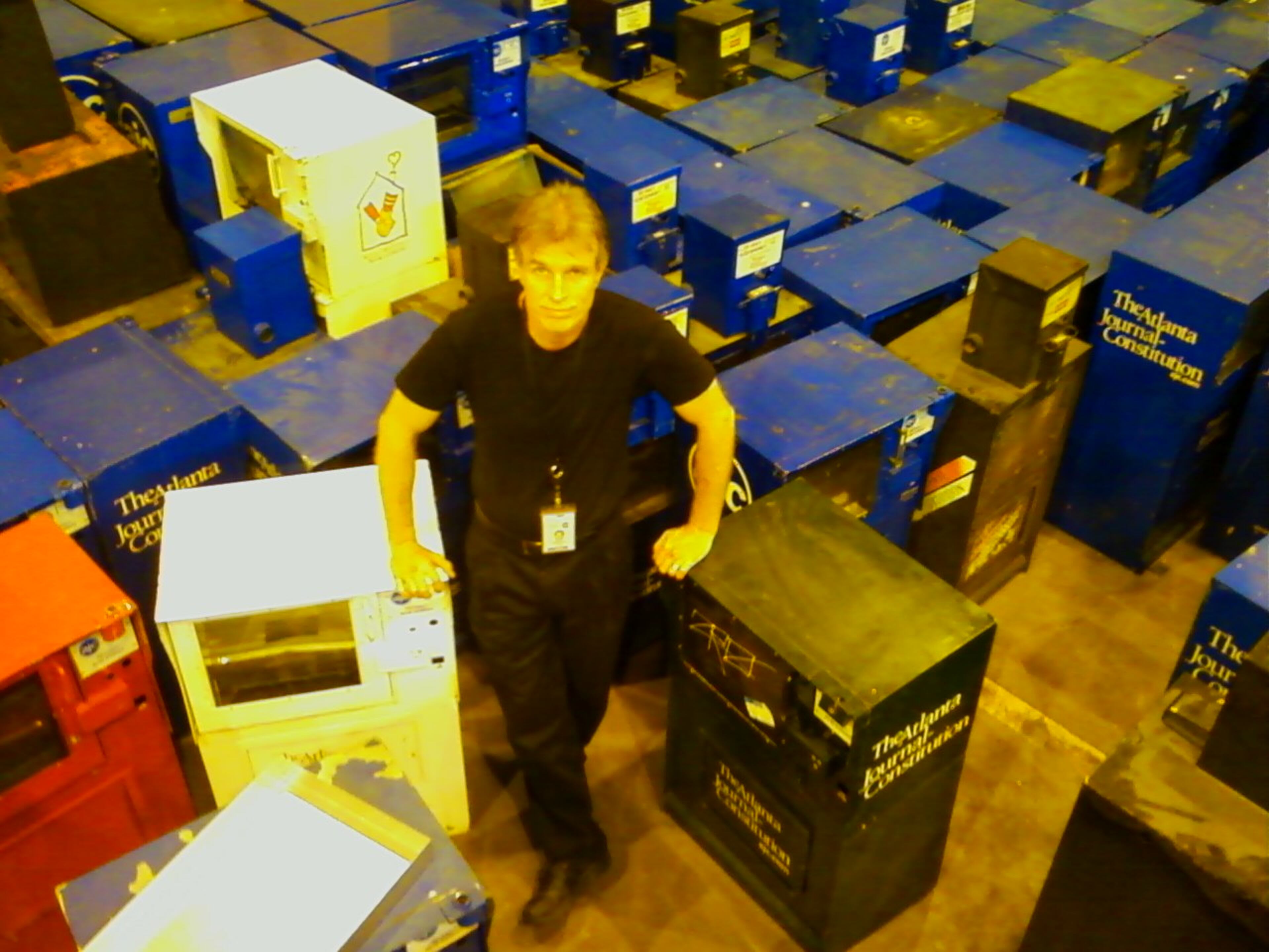 Bill Torpy poses with unneeded newspaper boxes as The Atlanta Journal-Constitution was set to leave its location at 72 Marietta St. (Mark Davis/AJC 2010)