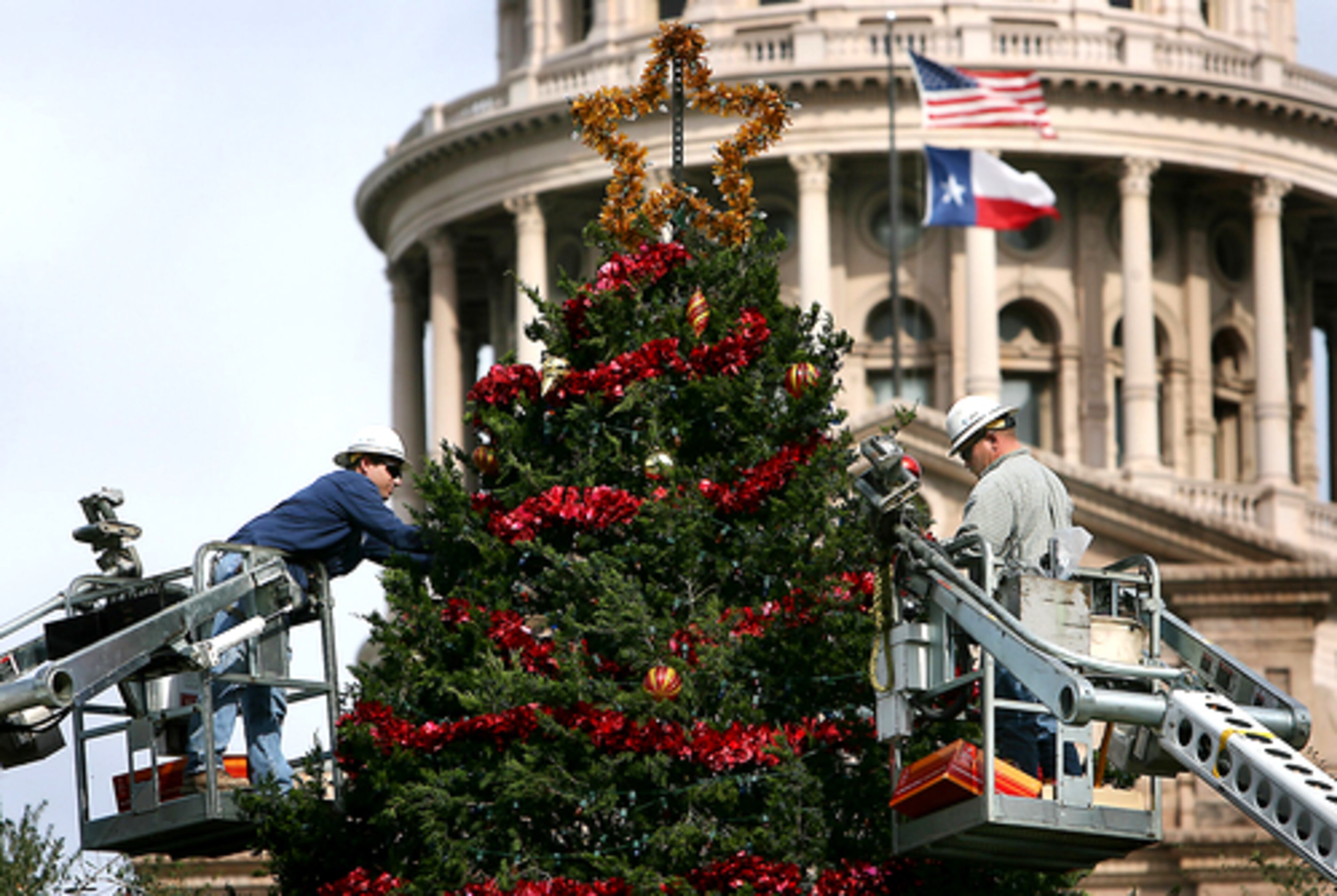 Austin, Texas: Troy Acosta and Scott Lunday decorate the Christmas tree in front of the Texas state Capitol.