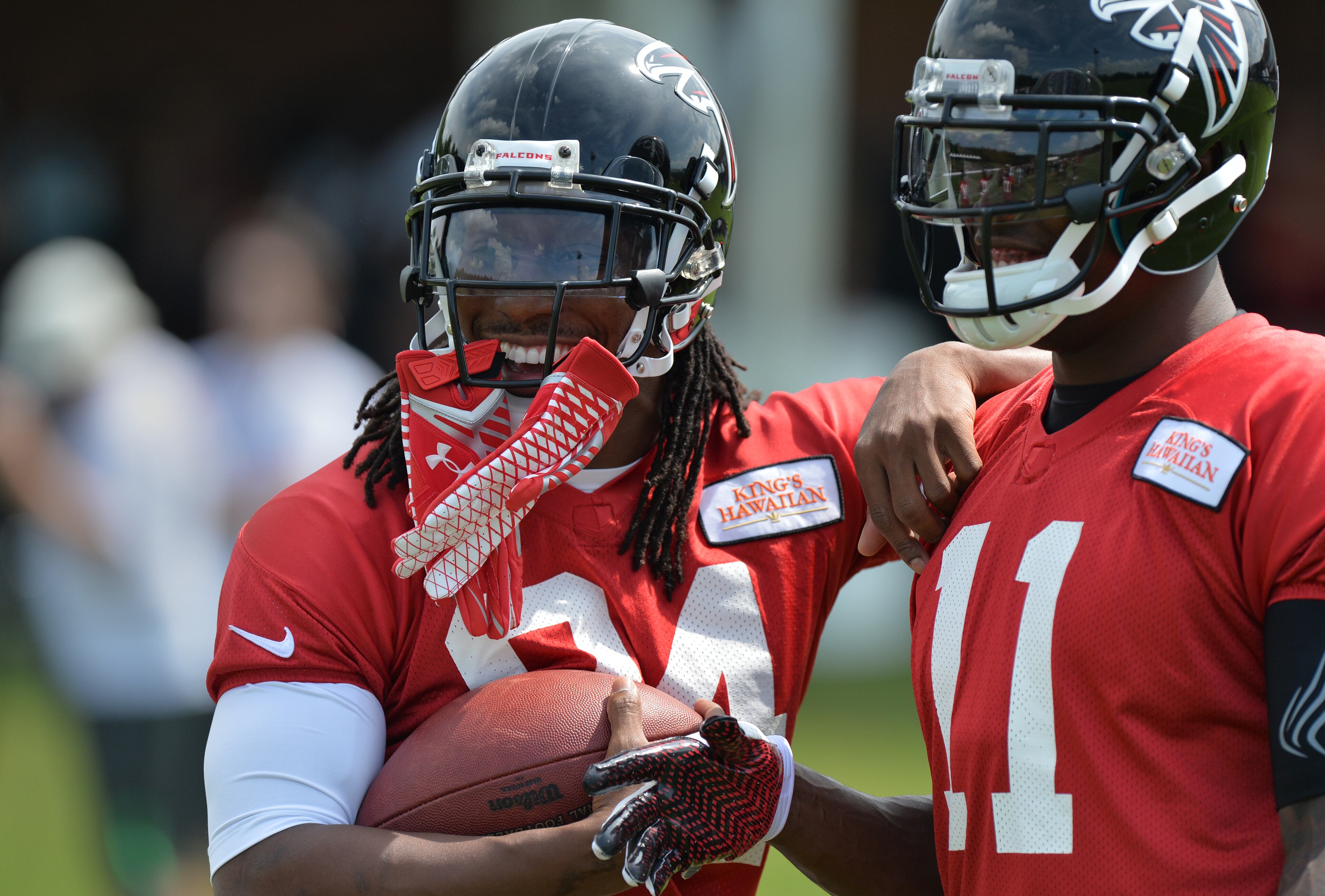 Atlanta Falcons wide receivers Roddy White (84) and Julio Jones joke around during training camp on Friday, July 25, 2014, in Flowery Branch.