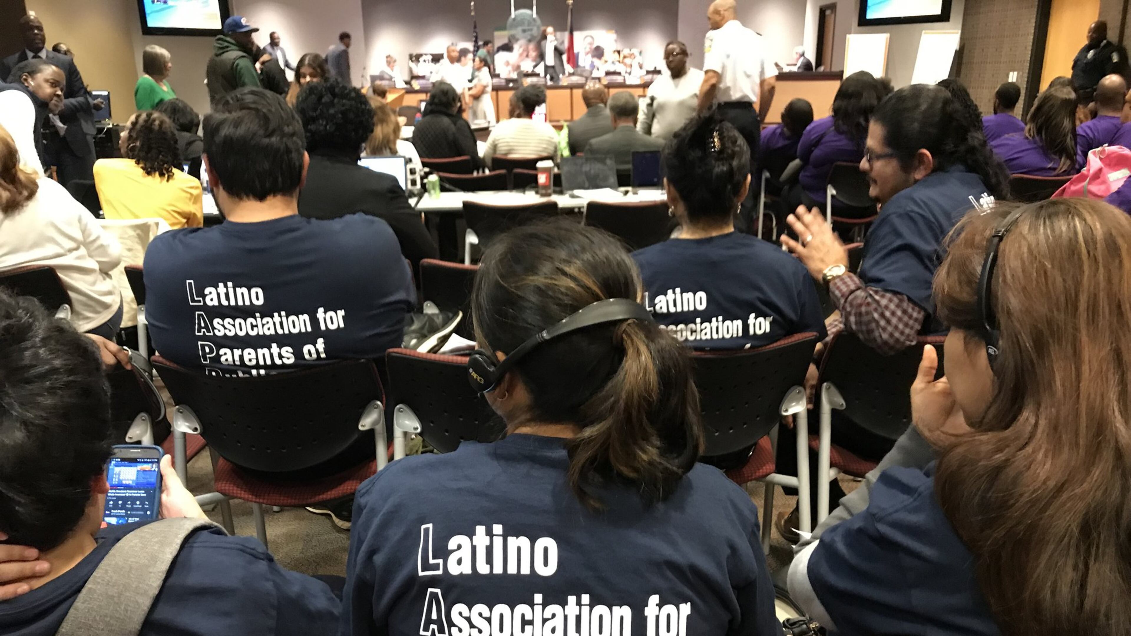 Members of the Latino Association for Parents of Public Schools use headphones to listen to an interpreter during a February meeting of the Atlanta Board of Education. VANESSA McCRAY/VANESSA.MCCRAY@AJC.COM