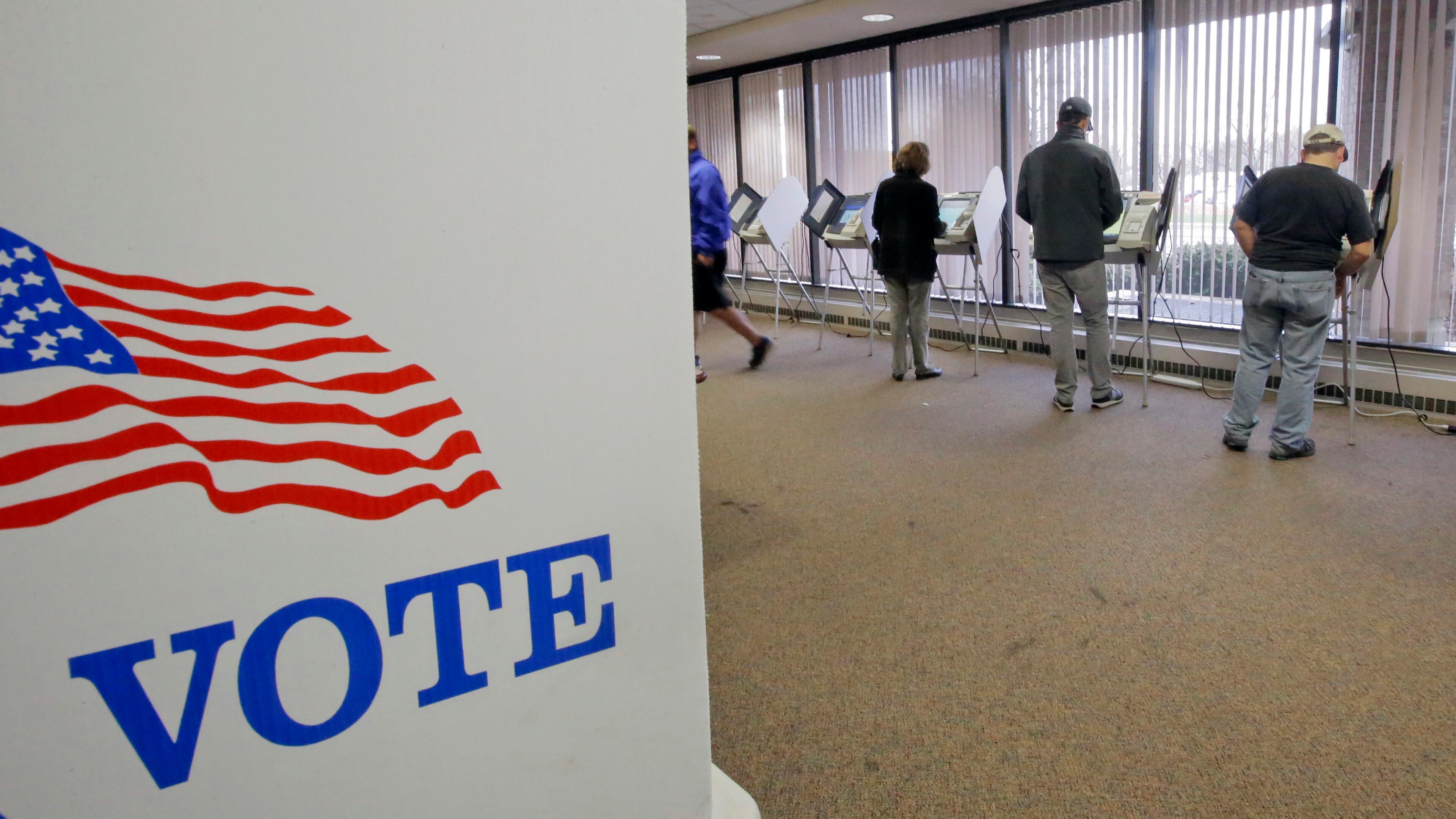 People vote during early voting for the 2016 General Election at the Salt Lake County Government Center on Tuesday, Nov. 1, 2016, in Salt Lake City. Hillary Clinton may not be accumulating the type of early-vote advantage her campaign wanted, but she continues to maintain an apparent edge over Donald Trump, with roughly one-fourth of all expected ballots cast in the 2016 election. (AP Photo/Rick Bowmer)