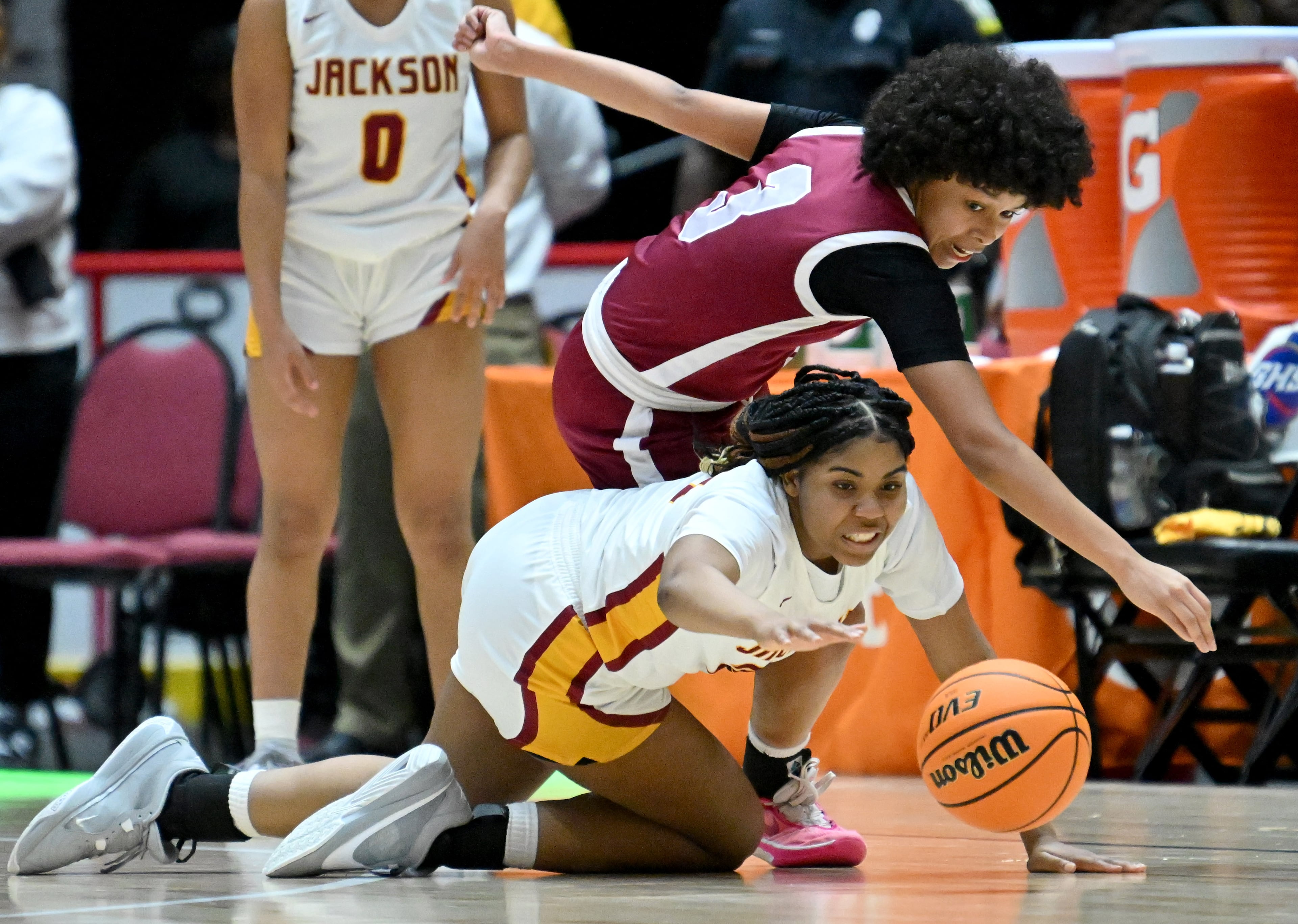 Jackson-Atlanta's British McKinney (bottom) and Midtown's Devin Bockman (3) go for a loose ball during the second half of GHSA Basketball Class 5A Girl’s State Championship game at the Macon Centreplex, Thursday, Mar. 7, 2024, in Macon. Jackson-Atlanta won 58-44 over Midtown. (Hyosub Shin / Hyosub.Shin@ajc.com)