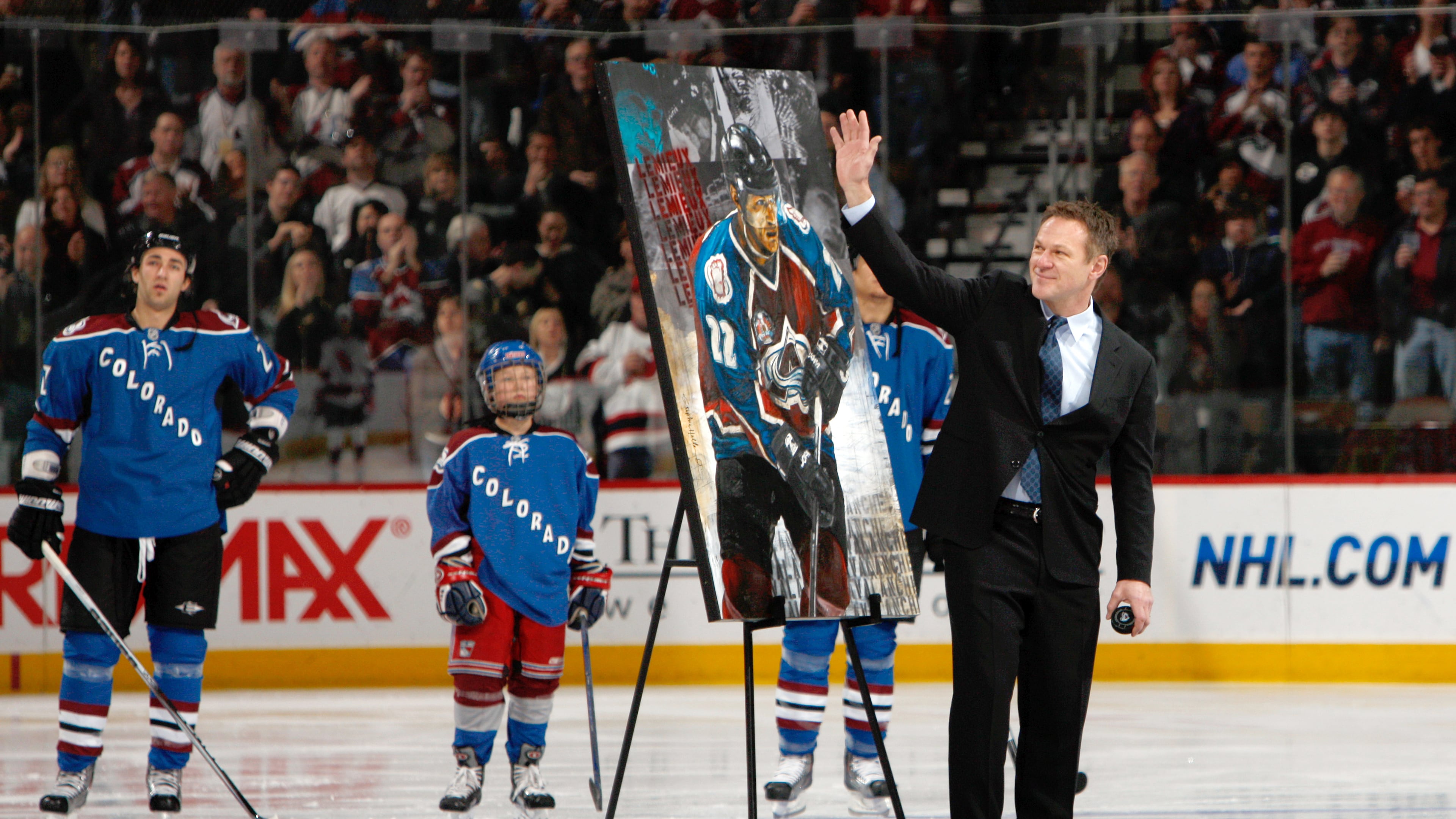 FILE - Retired Colorado Avalanche player Claude Lemieux waves to fans as he is honored for his years on the ice before the Avalanche host the New Jersey Devils in the first period of an NHL hockey game in Denver, Saturday, Jan. 16, 2010. (AP Photo/David Zalubowski, File)