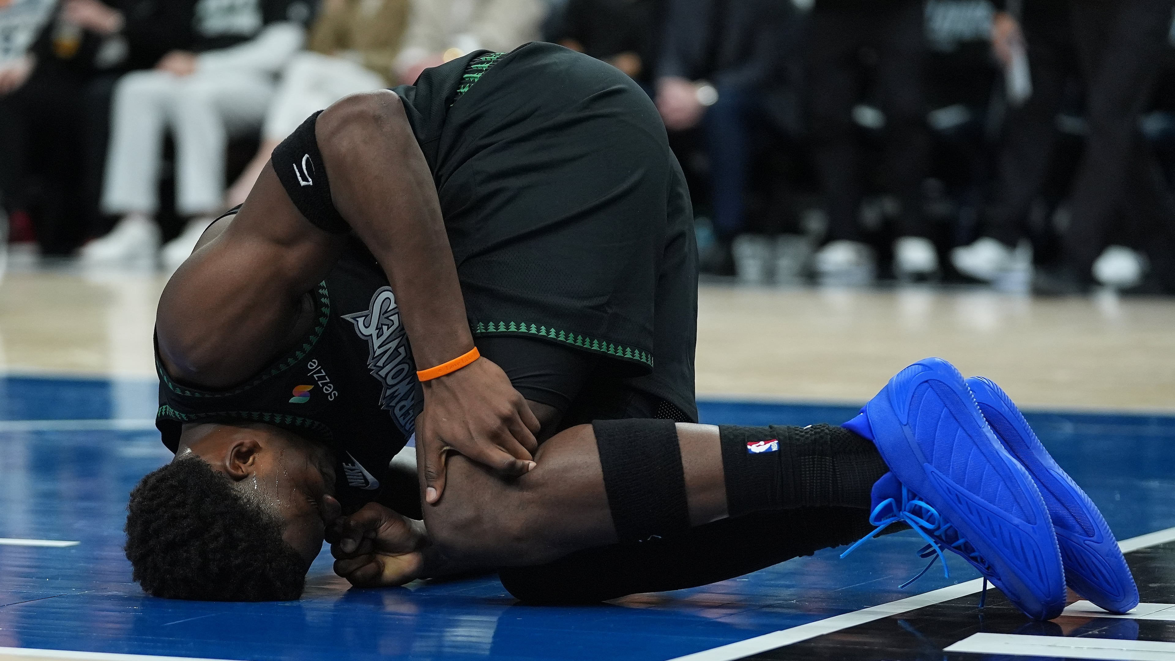 Minnesota Timberwolves guard Anthony Edwards kneels on the court after sustaining an injury during the first half of Game 4 of a first-round NBA basketball playoff series against the Denver Nuggets, Saturday, April 25, 2026, in Minneapolis. (AP Photo/Abbie Parr)
