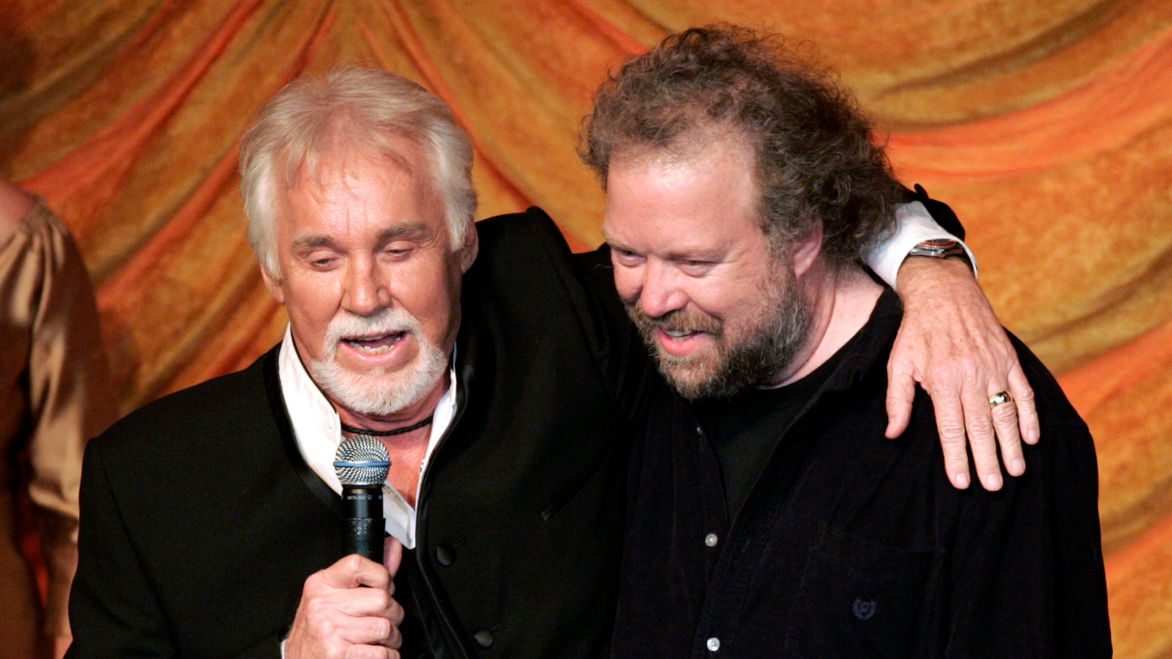FILE - Kenny Rogers, left, presents the ASCAP Creative Achievement Award to songwriter Don Schlitz at the ASCAP Country Music Awards in Nashville, Tenn., Monday, Oct. 15, 2007. (AP Photo/Mark Humphrey, File)