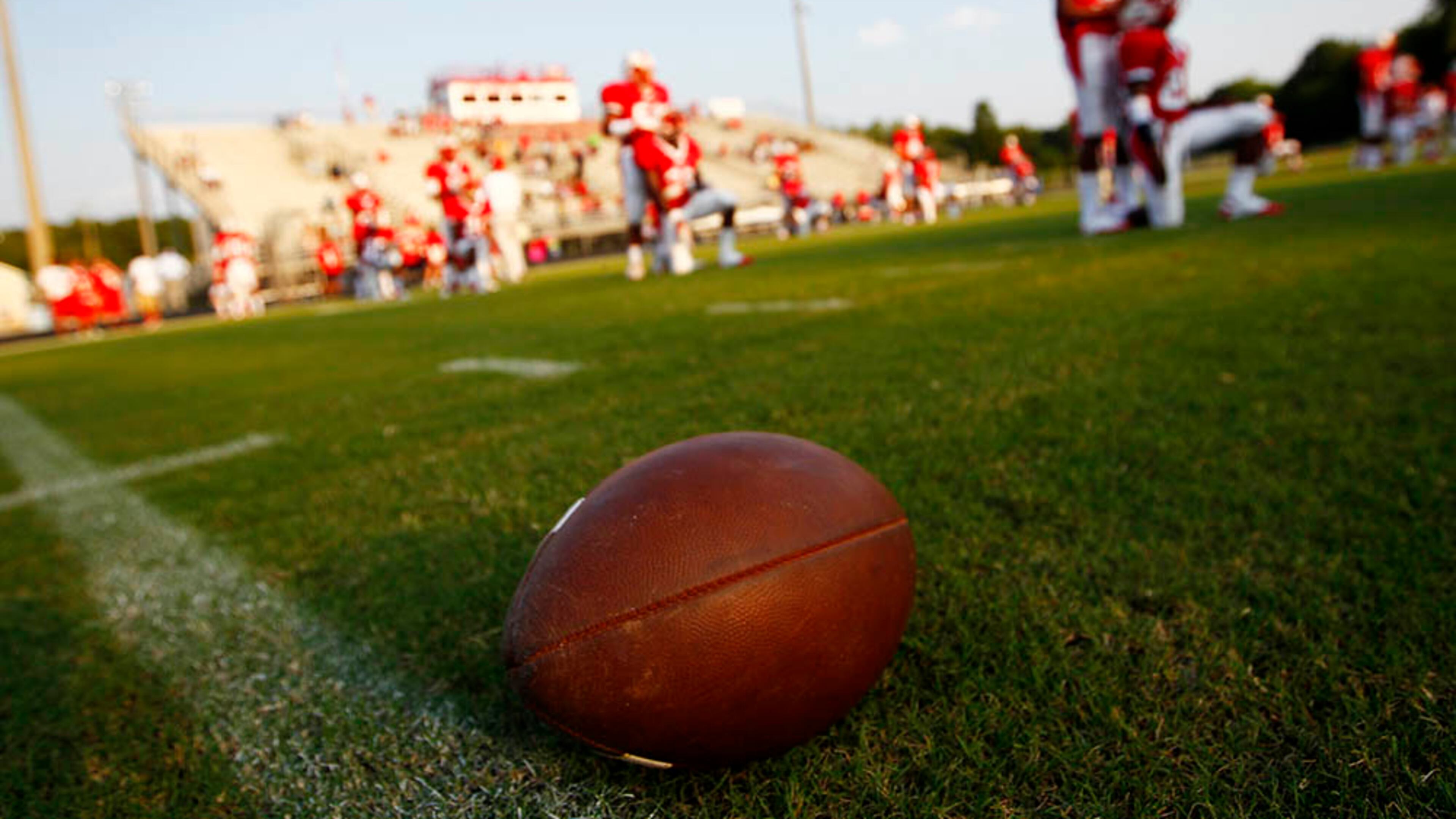 082611 - Tyrone, GA - Josh D. Weiss / Special A football rests on the field as Sandy Creeks players stretch at Sandy Creek High School in Tyrone on August 26, 2010.