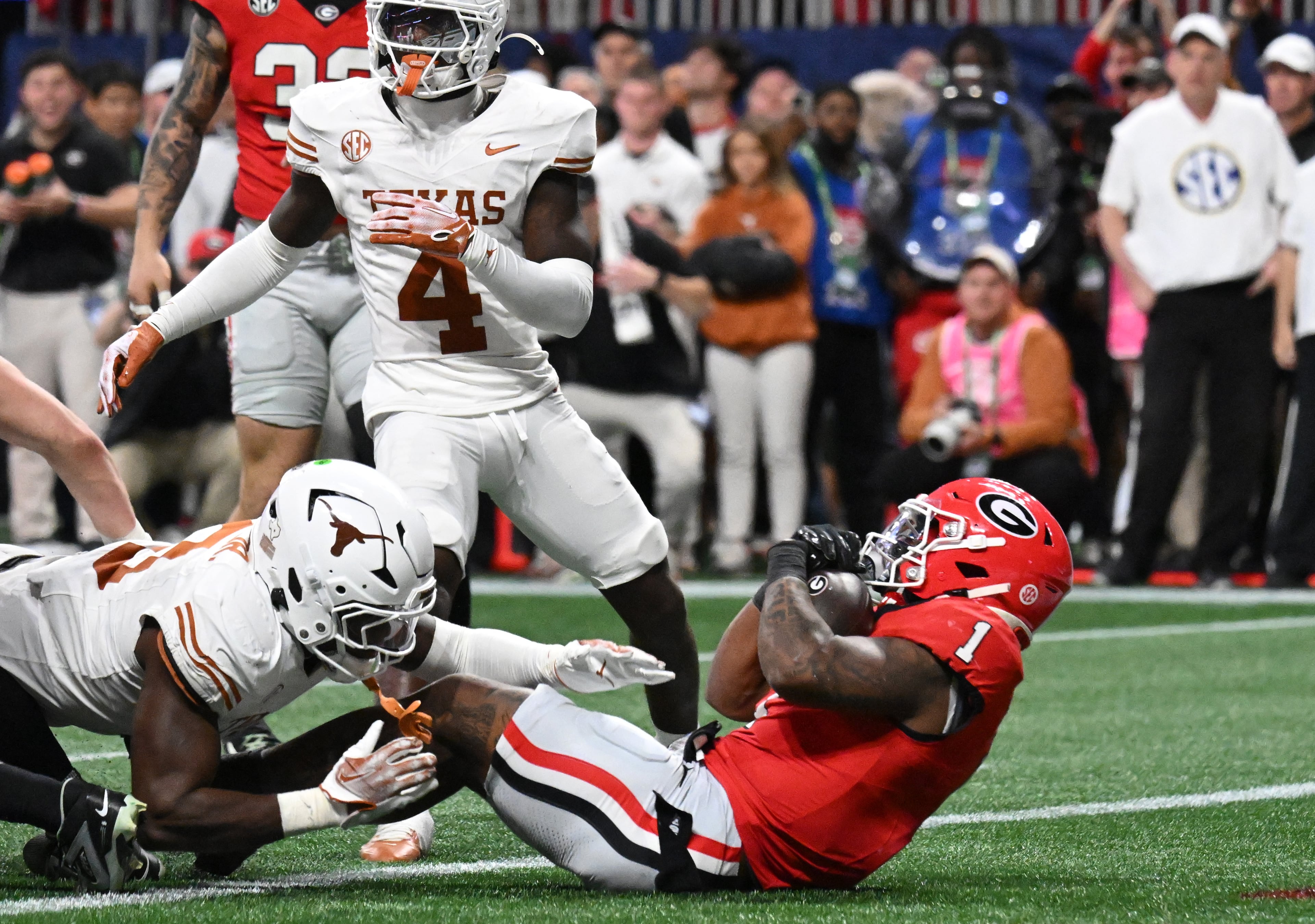 Georgia running back Trevor Etienne (1) scores the game winning touchdown in overtime during the SEC Championship football game at the Mercedes-Benz Stadium, Saturday, December 7, 2024, in Atlanta. Georgia won 22-19 over Texas in overtime. (Hyosub Shin / AJC)