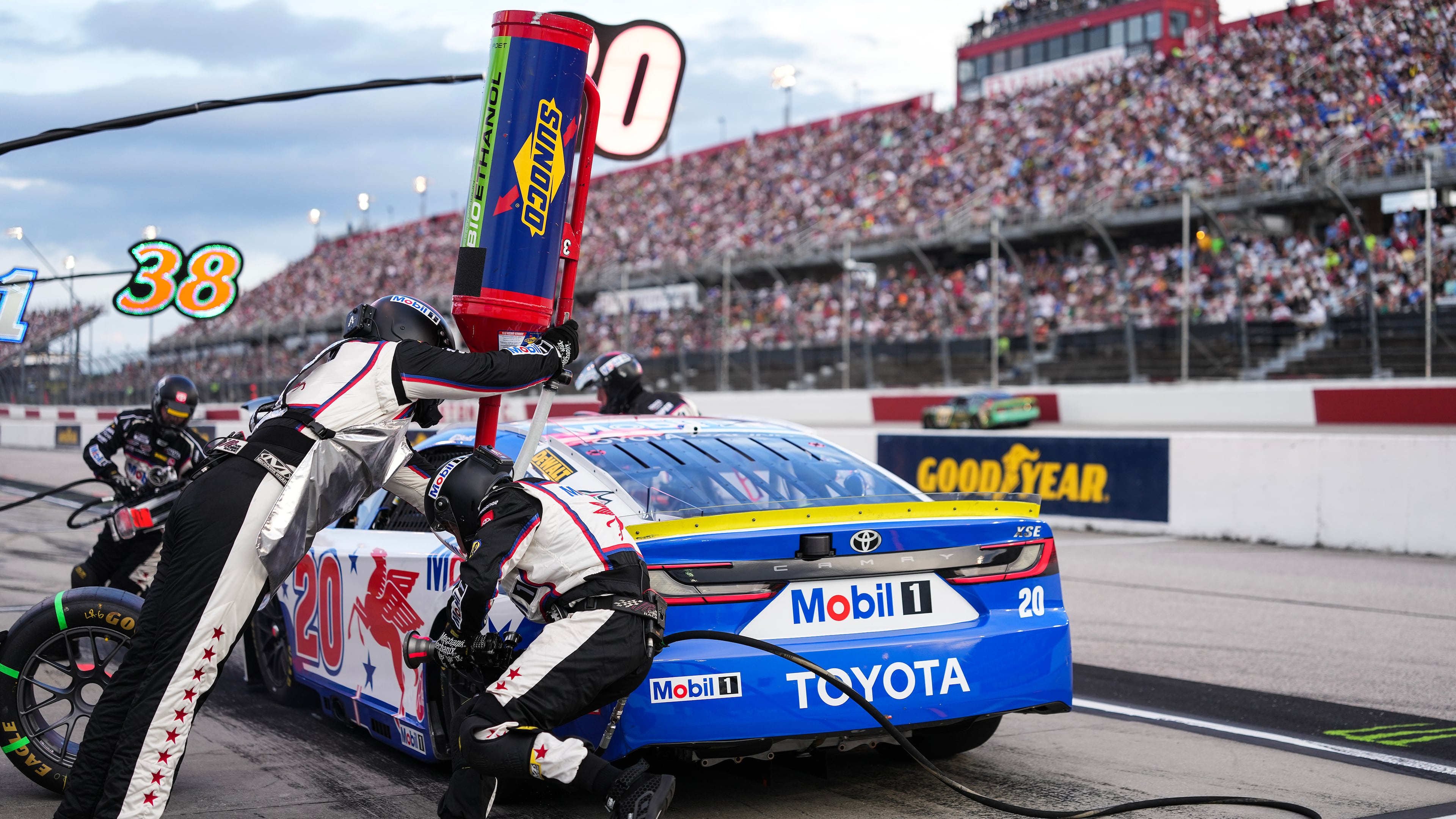 The pit crew for Christopher Bell rushes to complete a pit stop during a NASCAR Cup Series auto race at Darlington Raceway, Sunday, Sept. 6, 2026, in Darlington, S.C. (AP Photo/Matt Kelley)