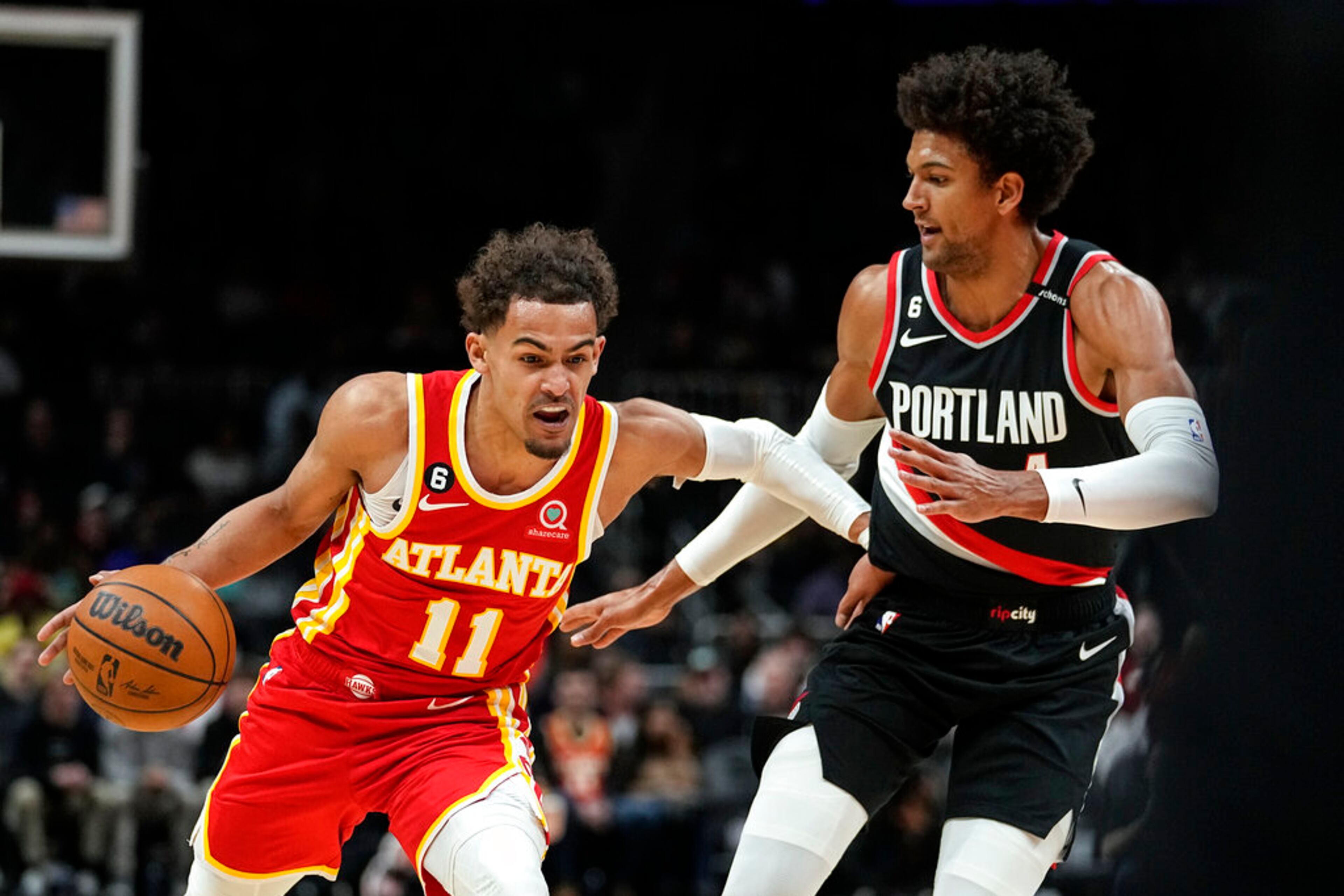 Atlanta Hawks guard Trae Young (11) drives against Portland Trail Blazers forward Greg Brown III, right, during the first half of an NBA basketball game Friday, March 3, 2023, in Atlanta. (AP Photo/John Bazemore)
