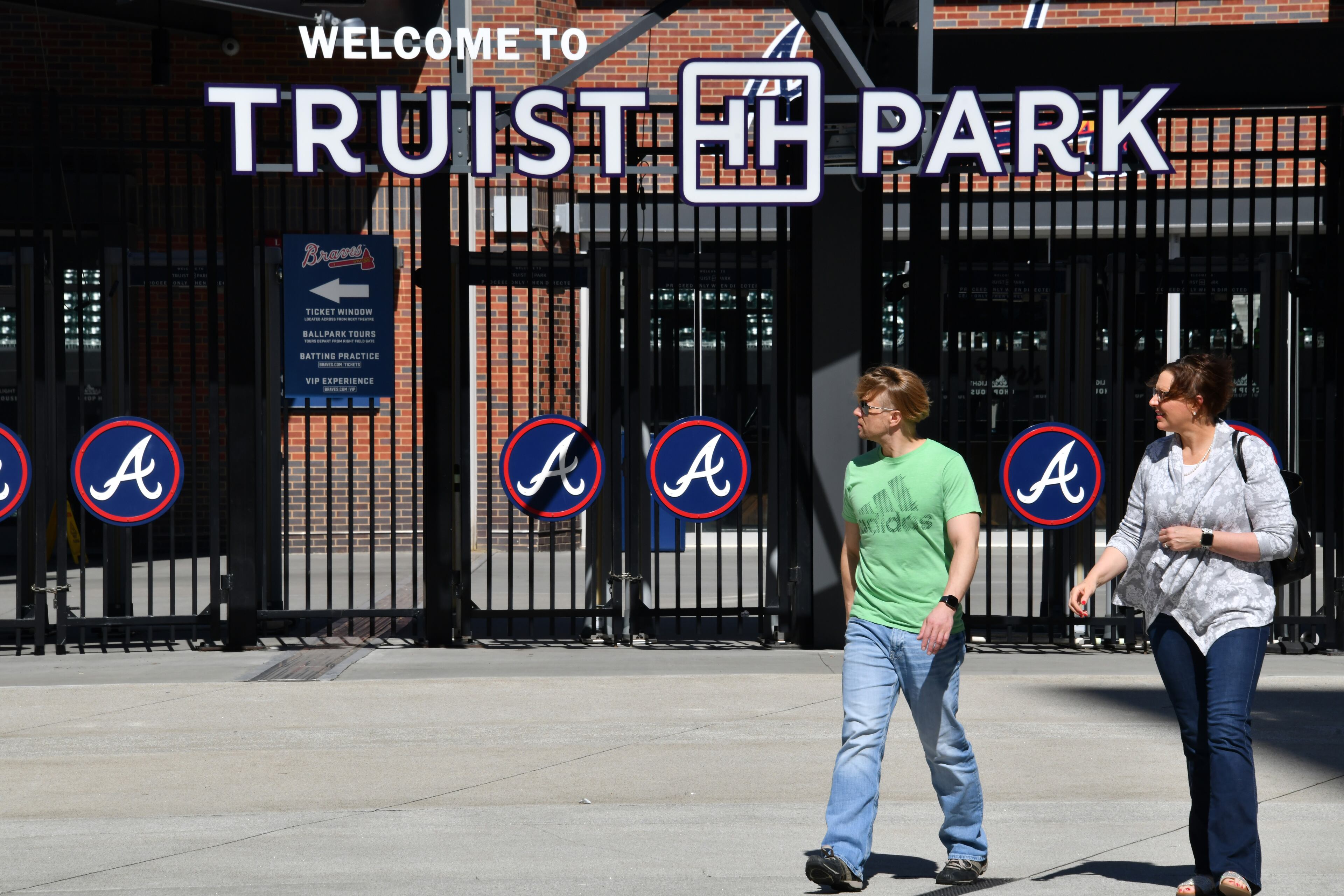 People walk past the Chop House gates at Truist Park on Wednesday, March 2, 2022. (Hyosub Shin / Hyosub.Shin@ajc.com)