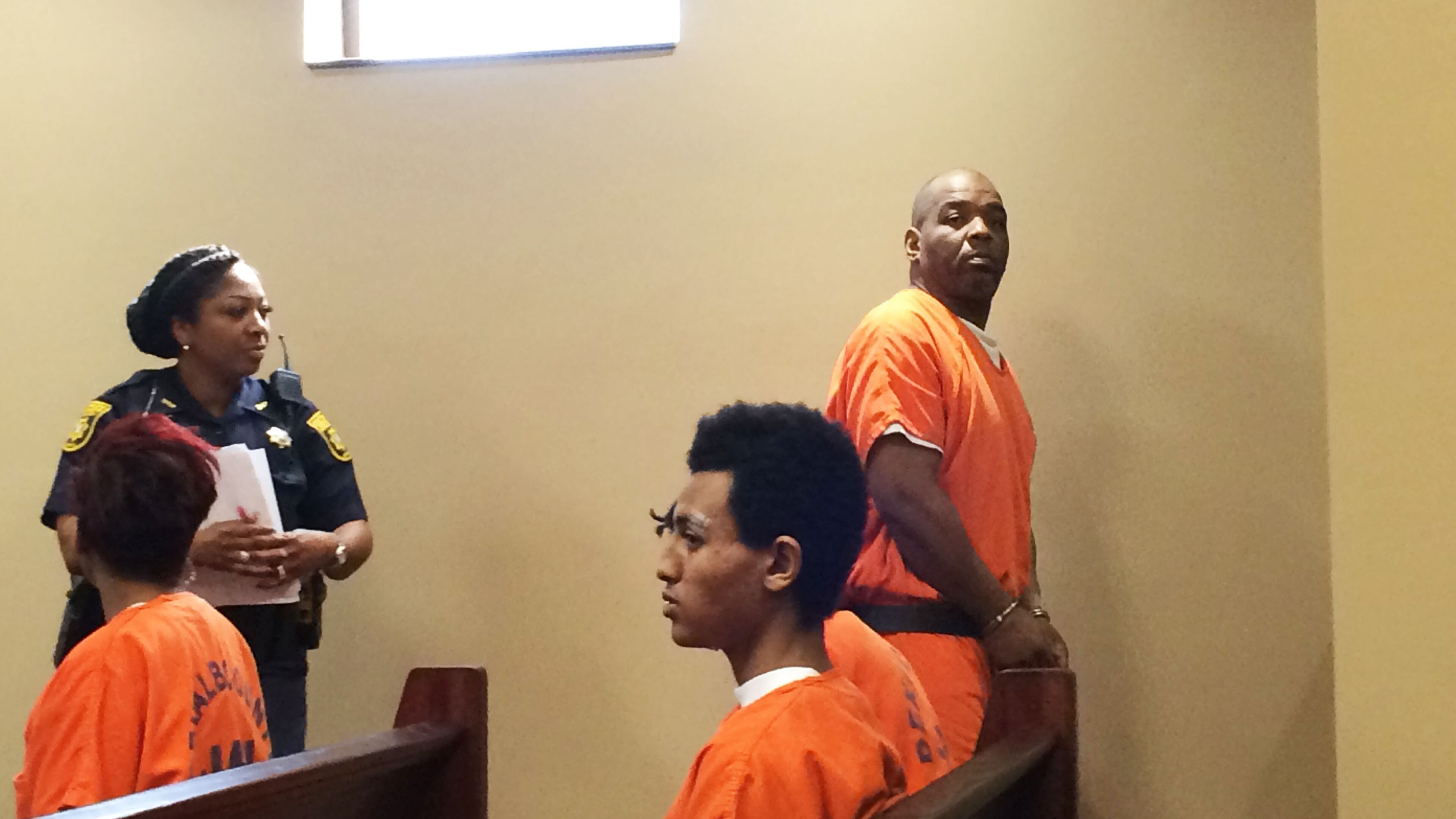 Charles Richey, standing at right, leaves court Thursday after a detective laid out the case against Richey, who is accused of murder in the death of a MARTA panhandler on a train.