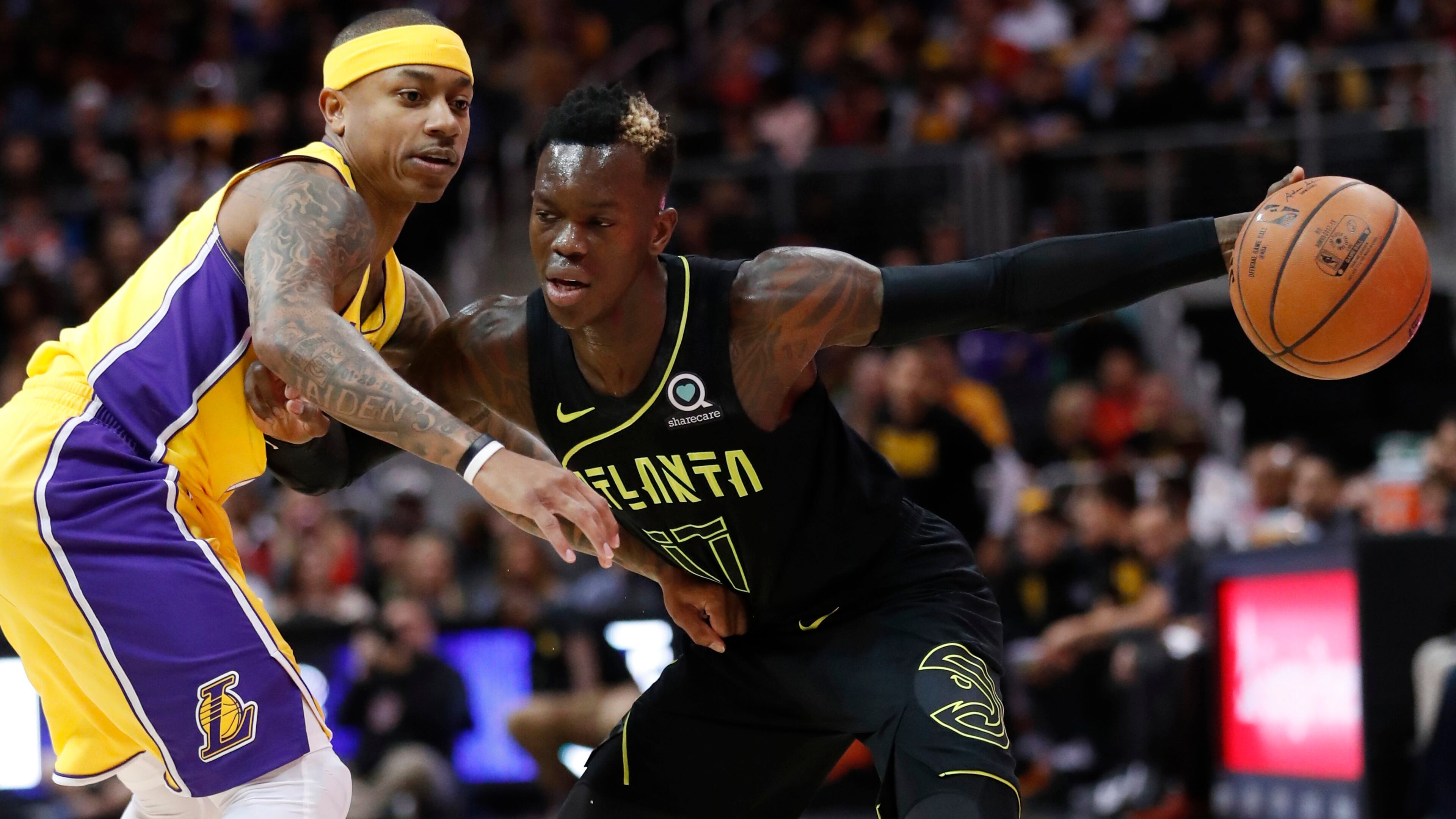 Atlanta Hawks guard Dennis Schroder (17) works against Los Angeles Lakers guard Isaiah Thomas (7) during the first half of an NBA basketball game in Atlanta Monday, Feb. 26, 2018. (AP Photo/John Bazemore)