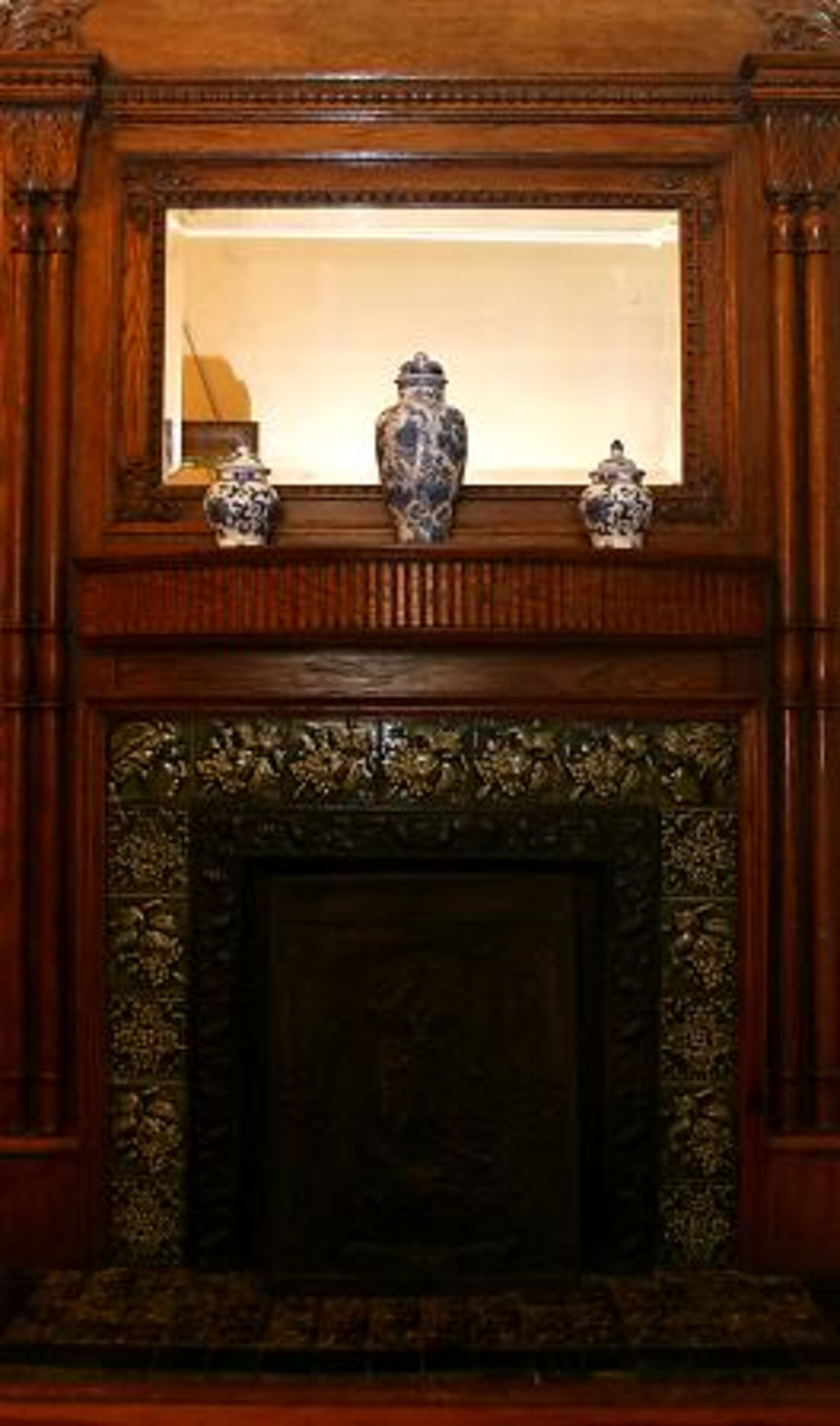 A fireplace with tile imported from London in the 1800s faces the entry hall. Ward is the third owner of the home that K.C. Williams built as a summer house atop a hill a half mile outside the Atlanta city limits in what is now Grant Park.