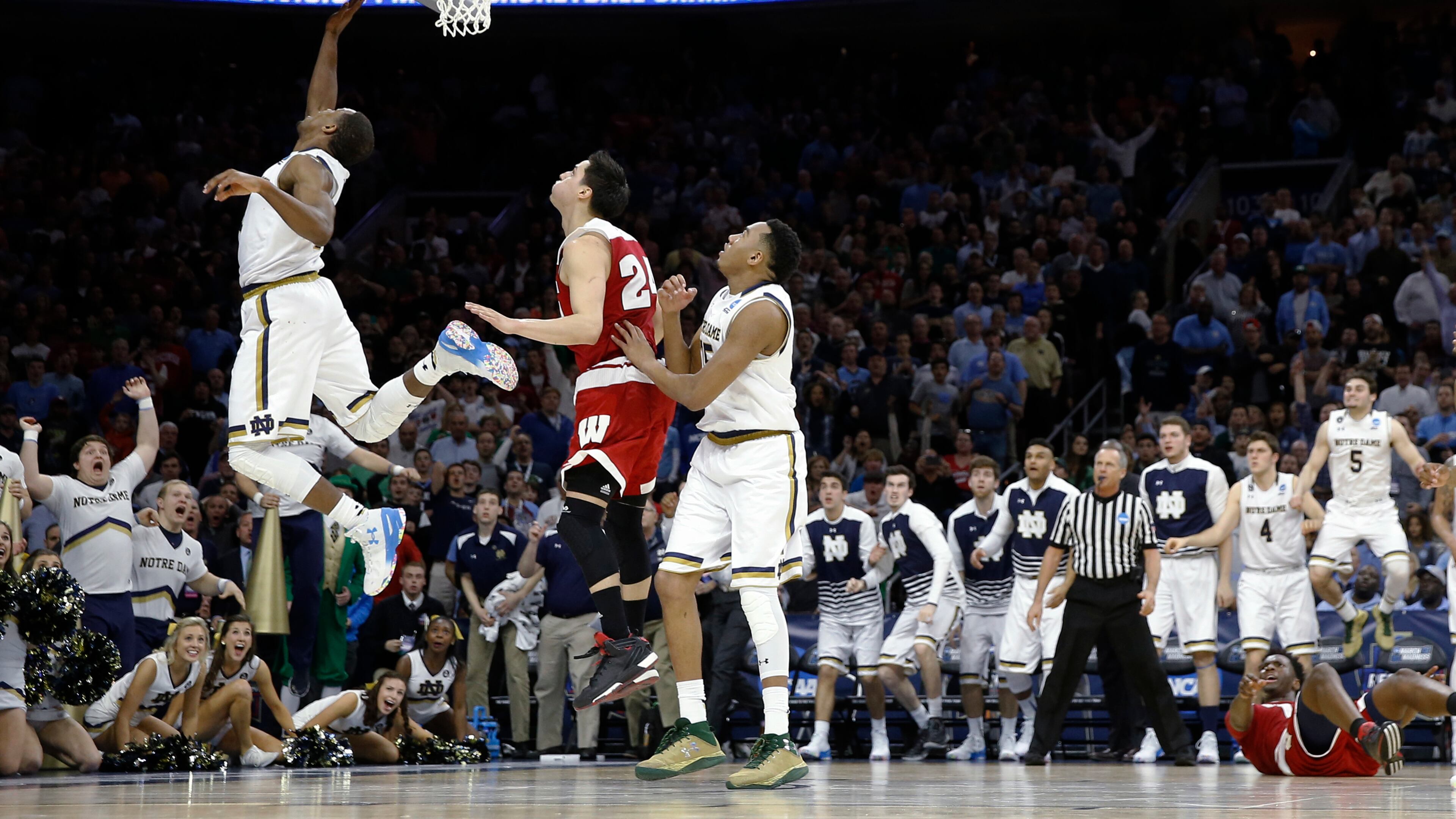 Notre Dame's Demetrius Jackson, left, goes up for a shot past Wisconsin's Bronson Koenig during the final minute of an NCAA college basketball game in the regional semifinals of the men's NCAA Tournament, Friday, March 25, 2016, in Philadelphia. Notre Dame won 61-56. (AP Photo/Chris Szagola)