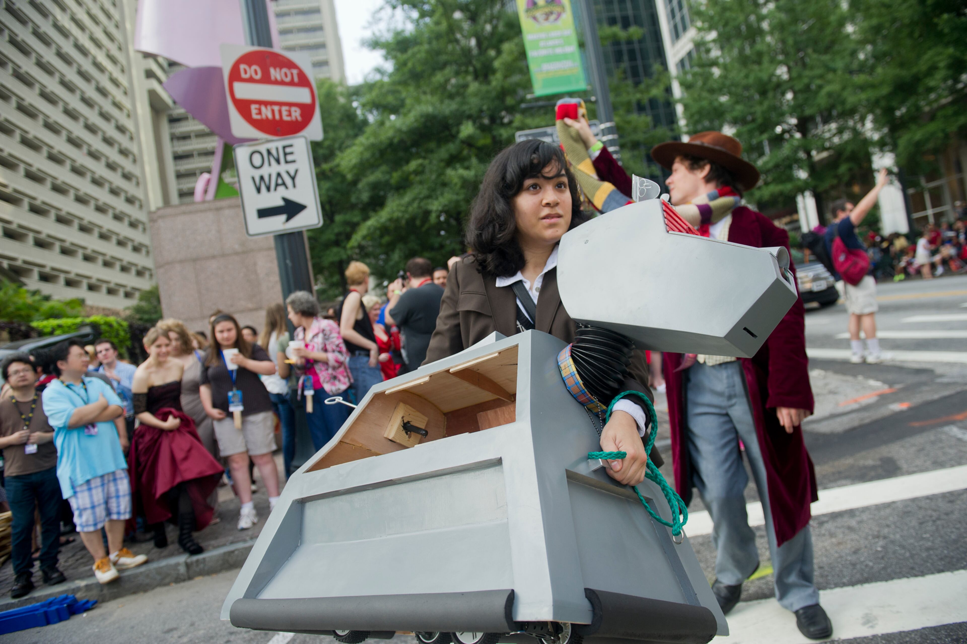 Rachel Burdge (center) carries her robot k-9 across Baker Street as she heads to the staging area for the annual DragonCon parade through downtown Atlanta on Saturday, August 31, 2013. This year 57,000 people were expected to attend the five day long event which is in its 27th year. JONATHAN PHILLIPS / SPECIAL