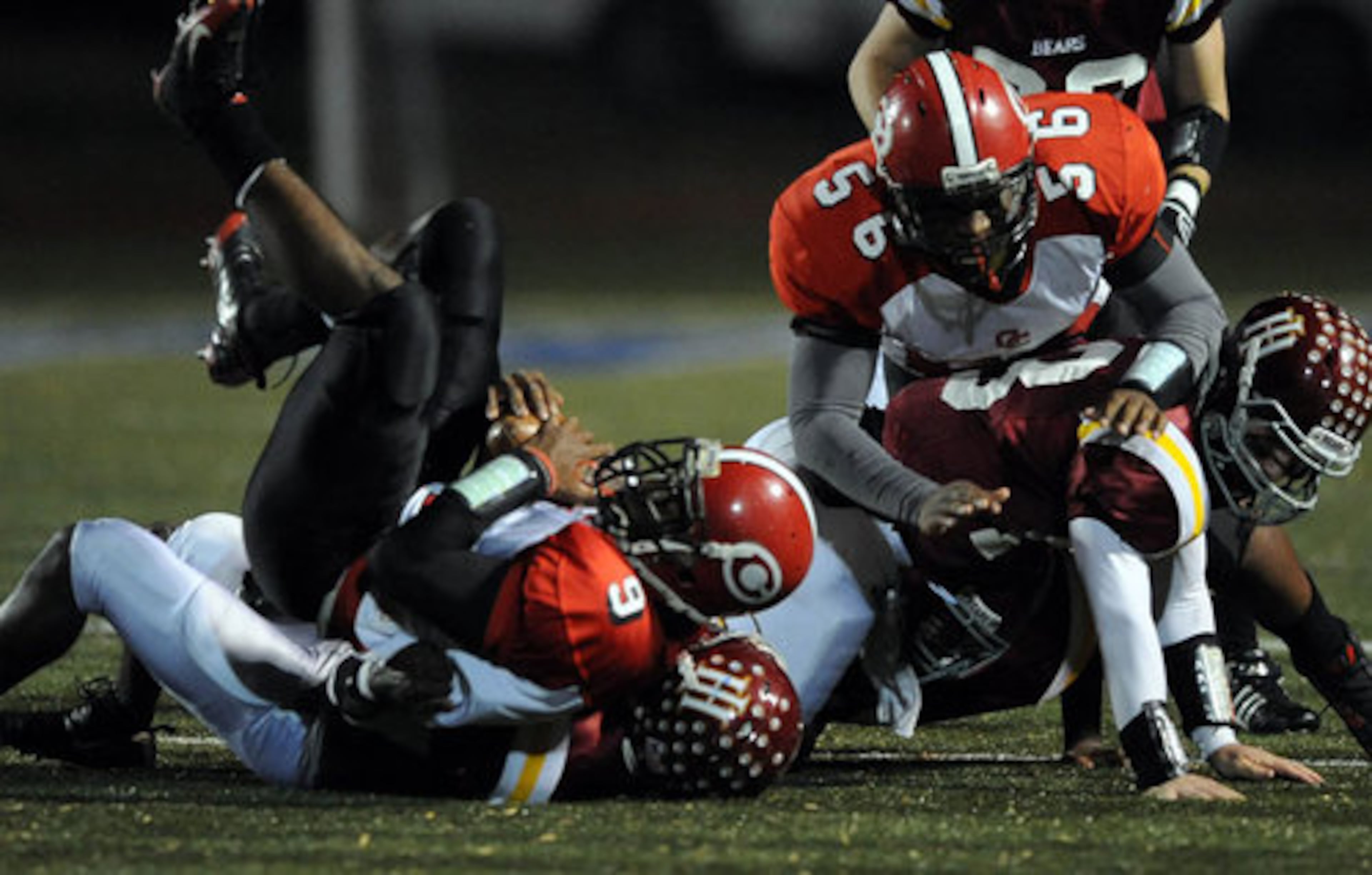 Clinch County's Vintavious Cooper (9) holds on to the ball as he's taken down by Holy Innocents' defenders.