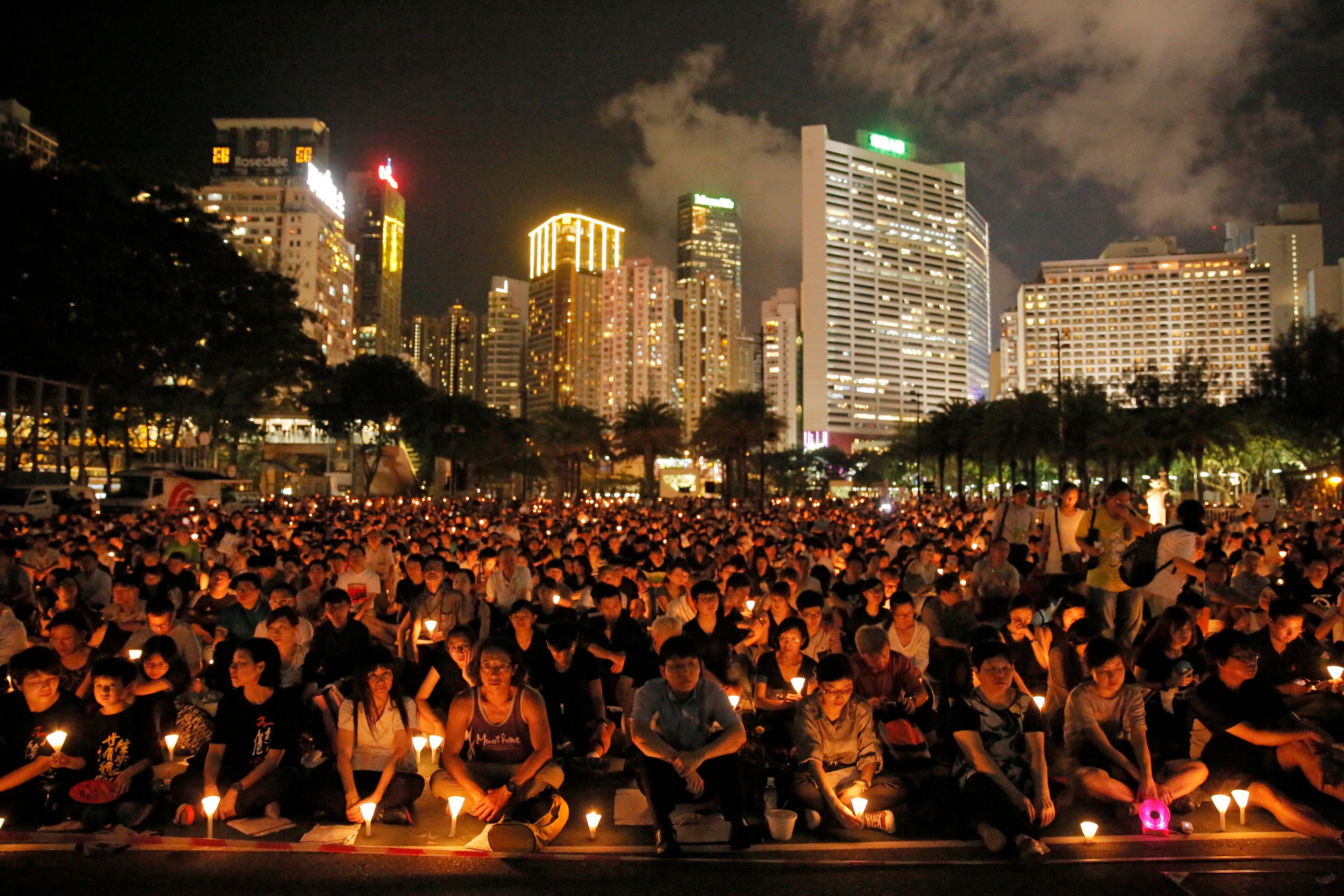 Tens of thousands of people attend a candlelight vigil at Victoria Park in Hong Kong Thursday, June 4, 2015. Hong Kongers joined the candlelight vigil Thursday night marking the crushing of the 1989 student-led Tiananmen Square protests, an annual commemoration that takes on greater meaning for the city's young after last autumn's pro-democracy demonstrations sharpened their sense of unease with Beijing. (AP Photo/Vincent Yu)