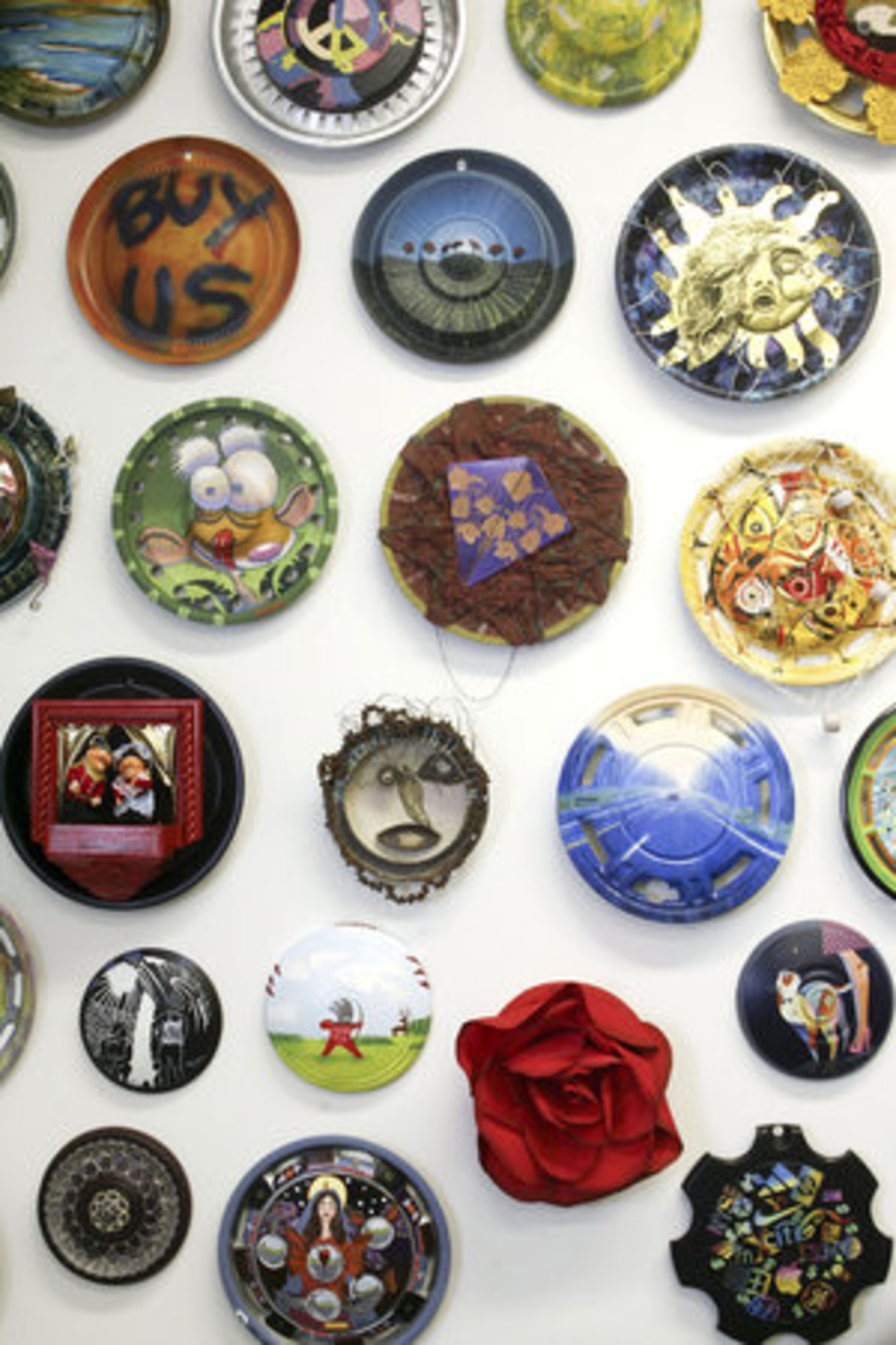 Several of the art pieces created from hubcaps that are part of the Landfillart Project are displayed in the art gallery of founder Ken Marquis in Wilkes-Barre, Pa. When complete, the collection will showcase 1,041 hubcaps, which are used in different mediums by artists to give them a second life.