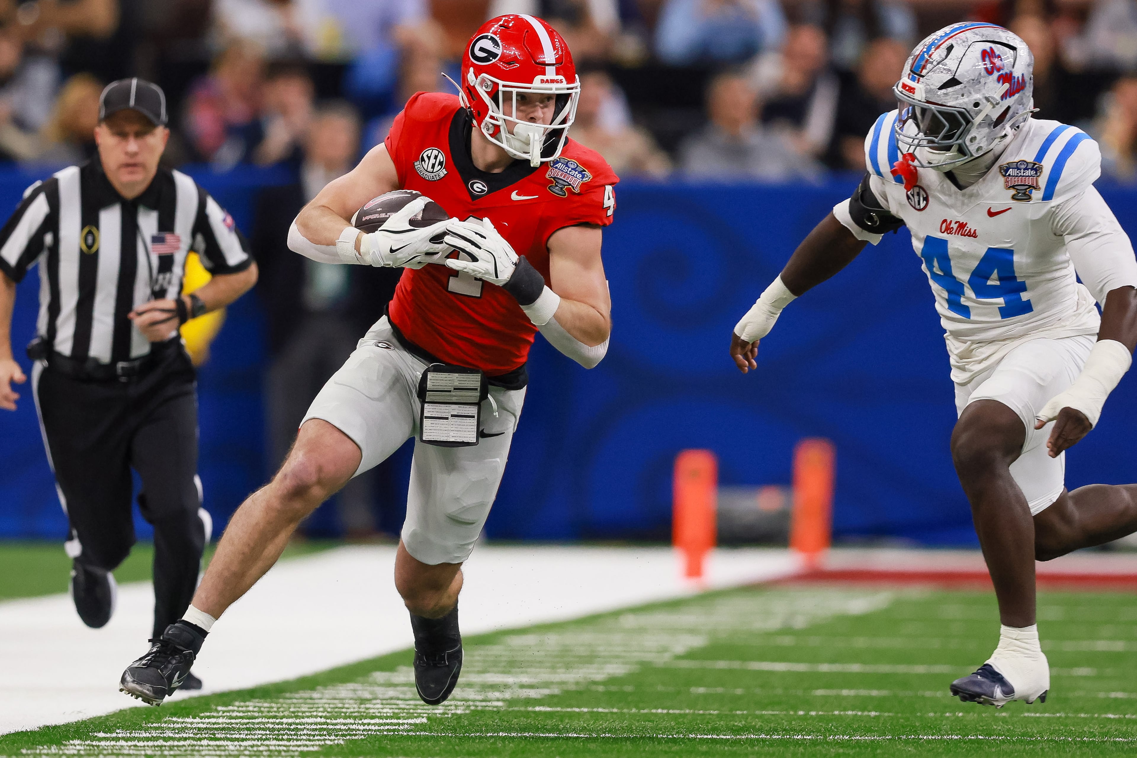 Georgia Bulldogs tight end Oscar Delp runs past Ole Miss Rebels linebacker Andrew Jones after a 16-yard pass reception during the first quarter of the Georgia vs. Ole Miss NCAA College Football Playoff quarterfinal game at the Sugar Bowl in the Caesars Superdome, Thursday, Jan. 1, 2026, in New Orleans. (Jason Getz/AJC)