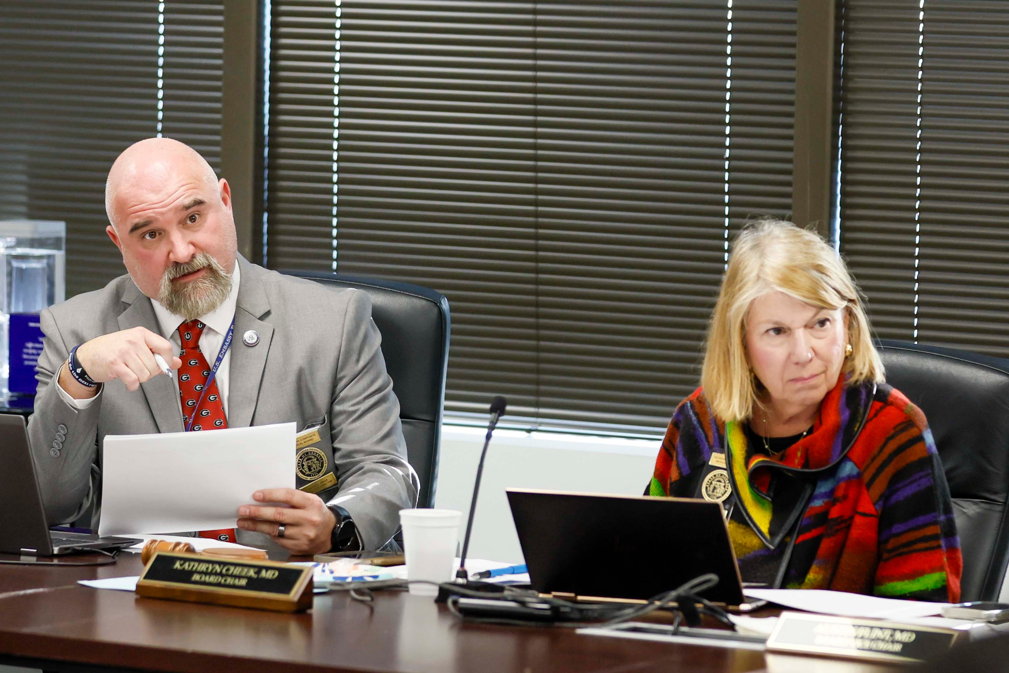 Jason S. Jones (left), executive director of the Georgia Composite Medical Board, and Kathryn Cheek, board chair, participate in the medicial board’s monthly meeting in November. The Georgia Composite Medical Board protects public health by overseeing the licensing and regulation of healthcare professionals in the state. (Miguel Martinez/AJC 2025)