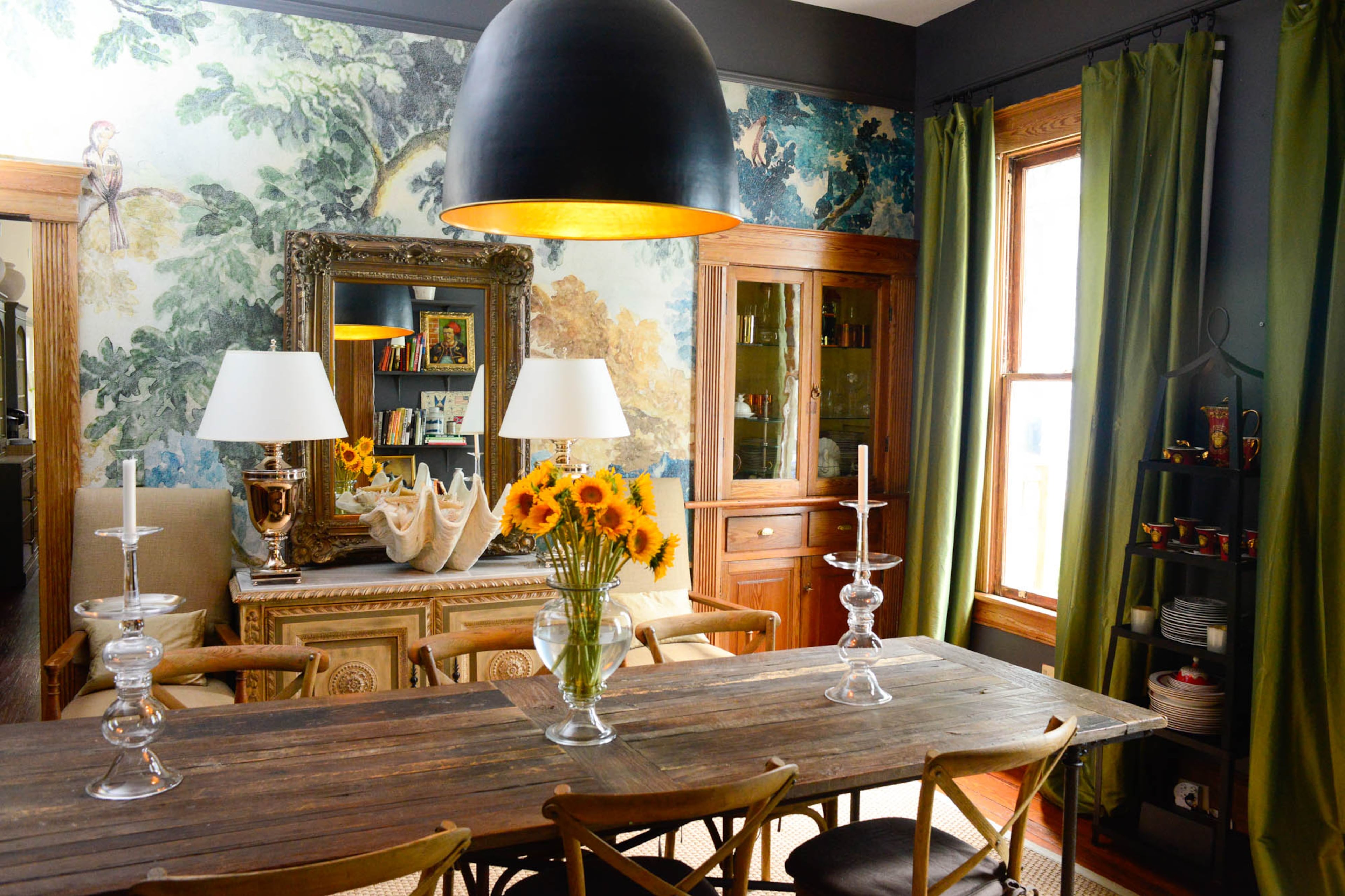 The mural wall painting gives the dining room an exotic feel, said homeowner Brad Resler. He's decorated the space with rustic, traditional, industrial and even whimsical elements through the furniture, accessories and art.