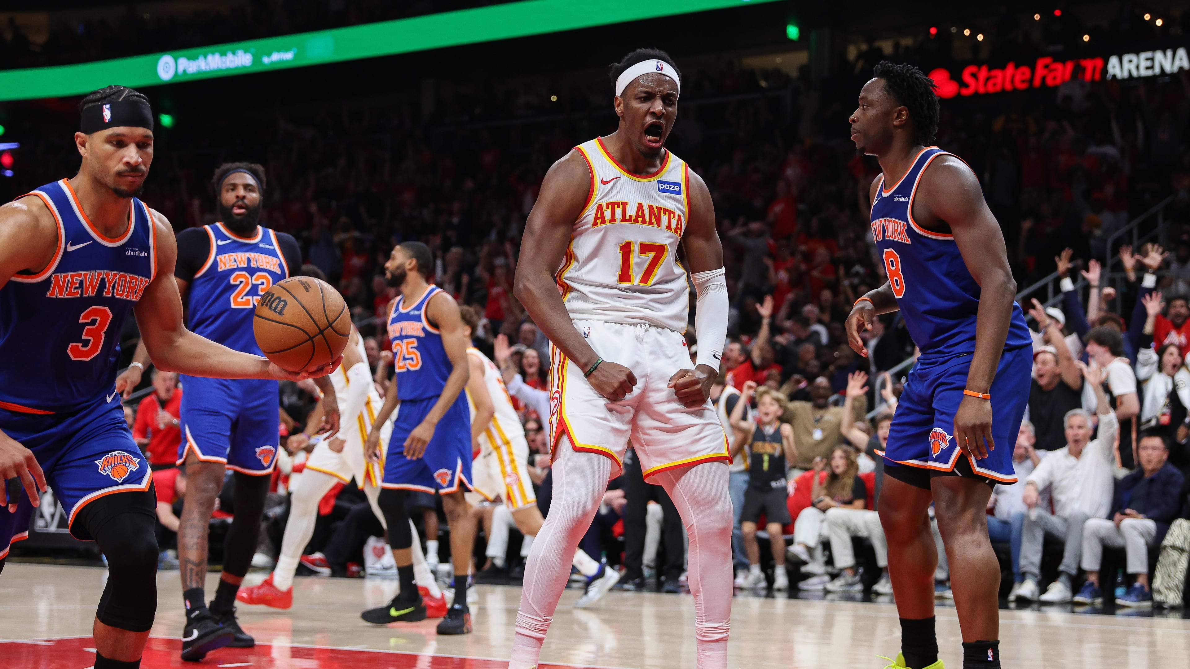 Atlanta Hawks forward Onyeka Okongwu (17) reacts after a dunk against New York Knicks guard Josh Hart (3) and forward Og Anunoby (8) during the first half in Game 3 of a first-round NBA playoffs basketball series, Thursday, April 23, 2026, in Atlanta. (Colin Hubbard/AP)