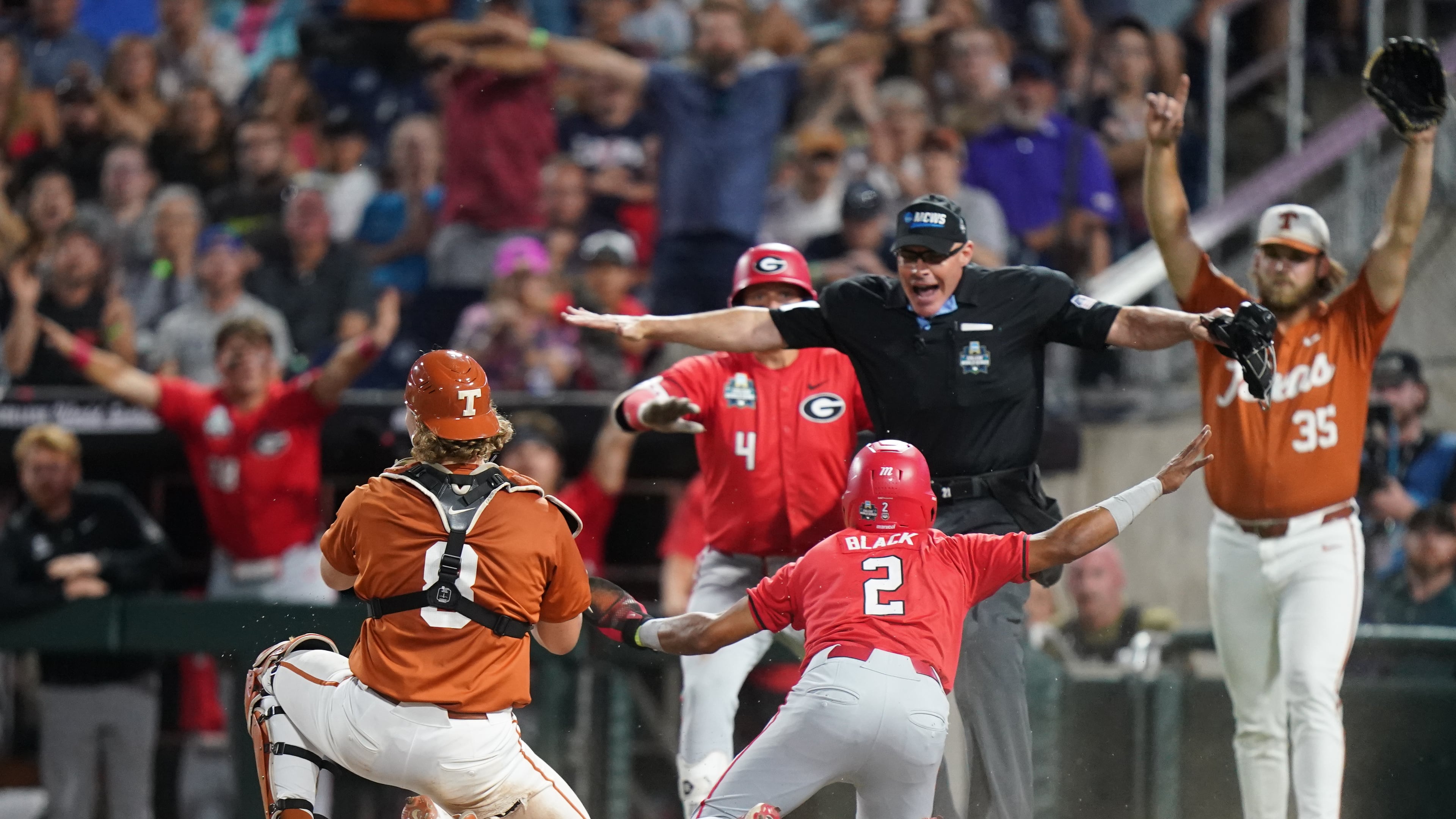 Georgia infielder Ryan Black slides safely into home and scores the second run of the game in the seventh inning during an NCAA baseball College World Series elimination game against Texas, Tuesday, June 16, 2026, in Omaha, Neb. (Vera Nieuwenhuis/AP)