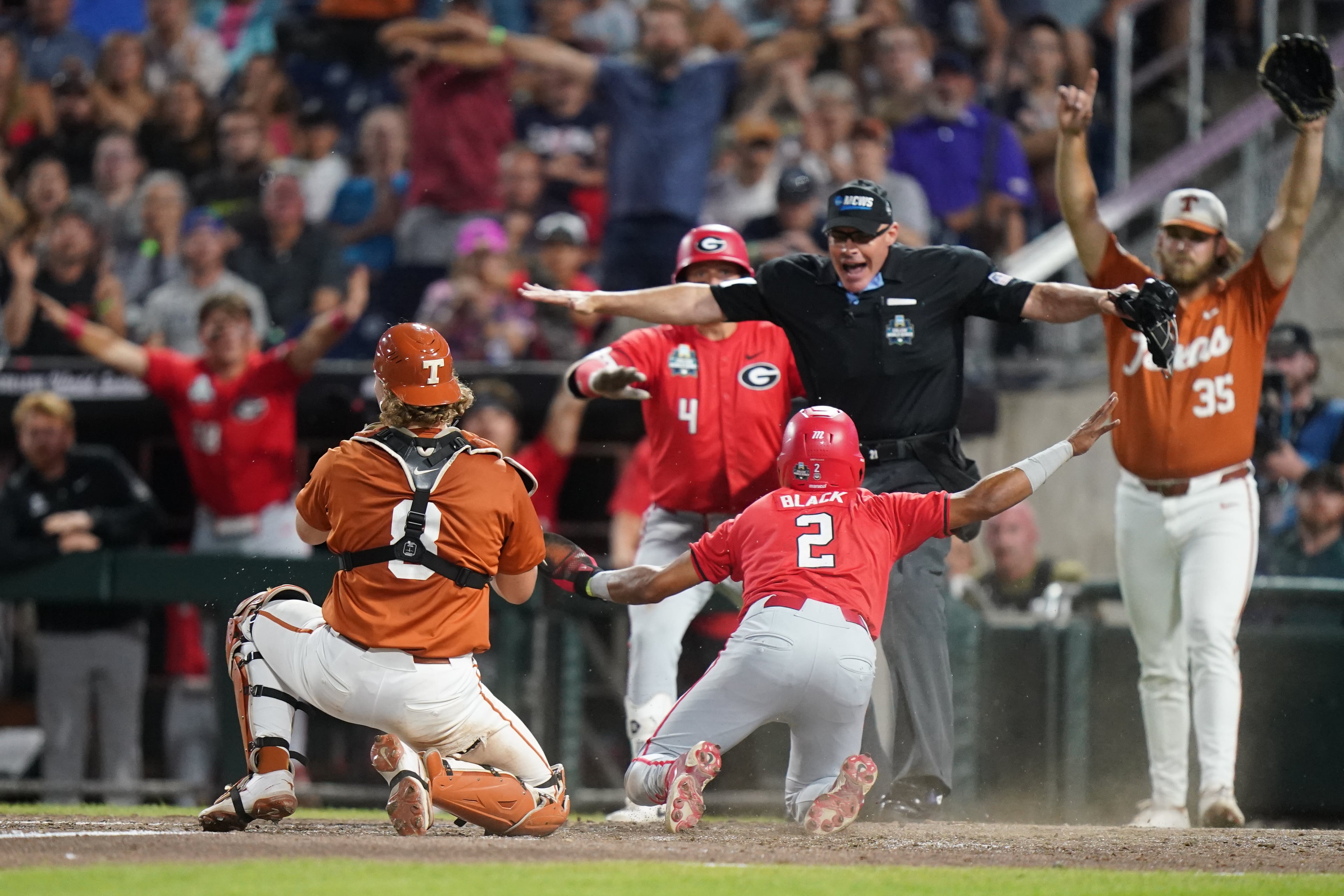Georgia infielder Ryan Black (2) slides safely into home and scores the second run of the game in the seventh inning during an NCAA baseball College World Series elimination game against Texas, Tuesday, June 16, 2026 in Omaha, Neb. Georgia won 2-0. (AP Photo/Vera Nieuwenhuis)
