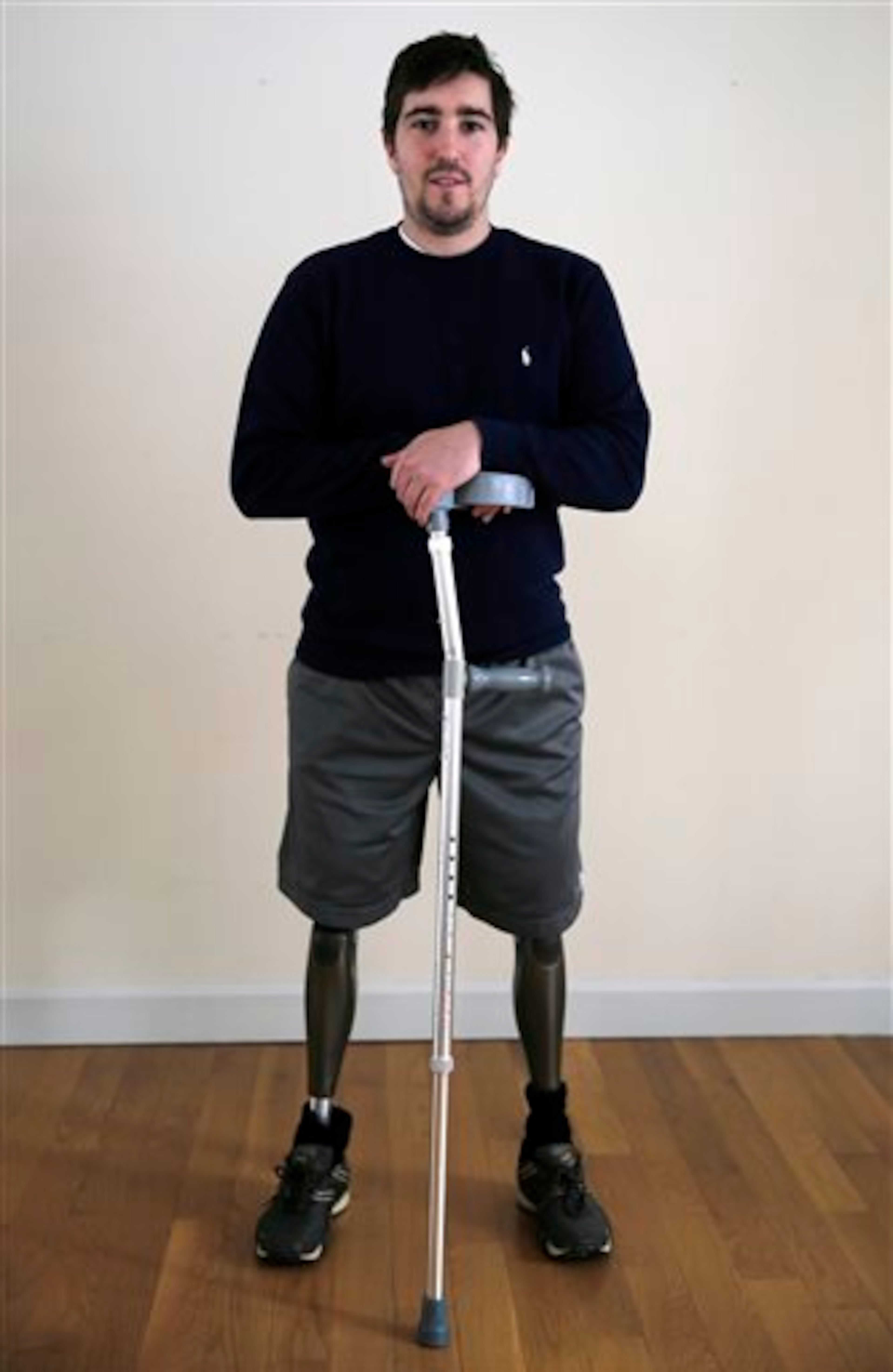 In this Friday, March 14, 2014 photo, Jeff Bauman stands in his home in Carlisle, Mass. Bauman, who lost both of his legs in the Boston Marathon bombings, helped identify one of the two brothers accused of setting off the explosions, which killed three and injured more that 260 others. (AP Photo/Charles Krupa)