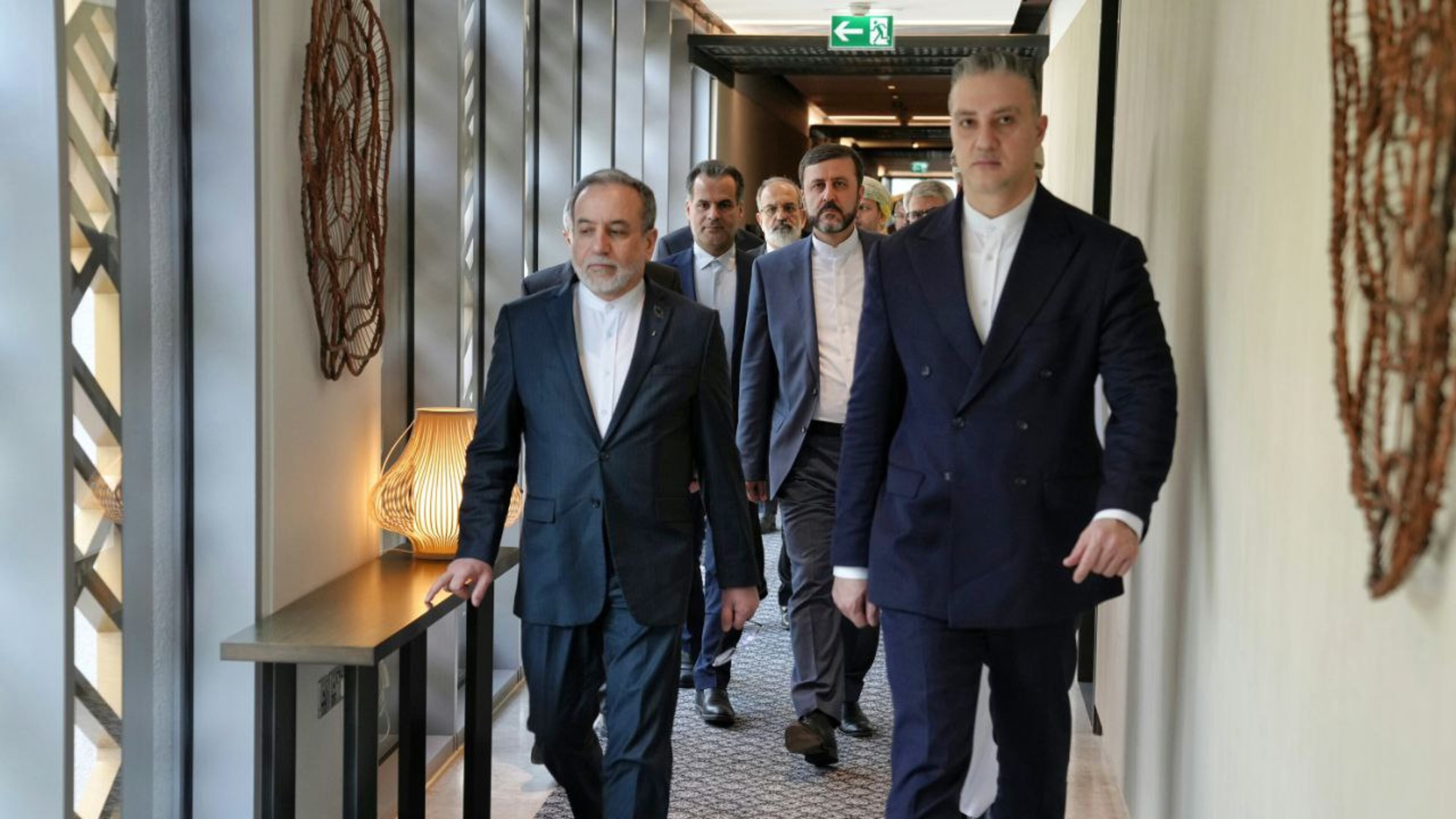 In this photo released by the Iranian Foreign Ministry, Iranian Foreign Minister Abbas Araghchi, left, heads to venue for talks between Iran and the U.S., in Muscat, Oman, Friday, Feb. 6, 2026. (Iranian Foreign Ministry via AP)