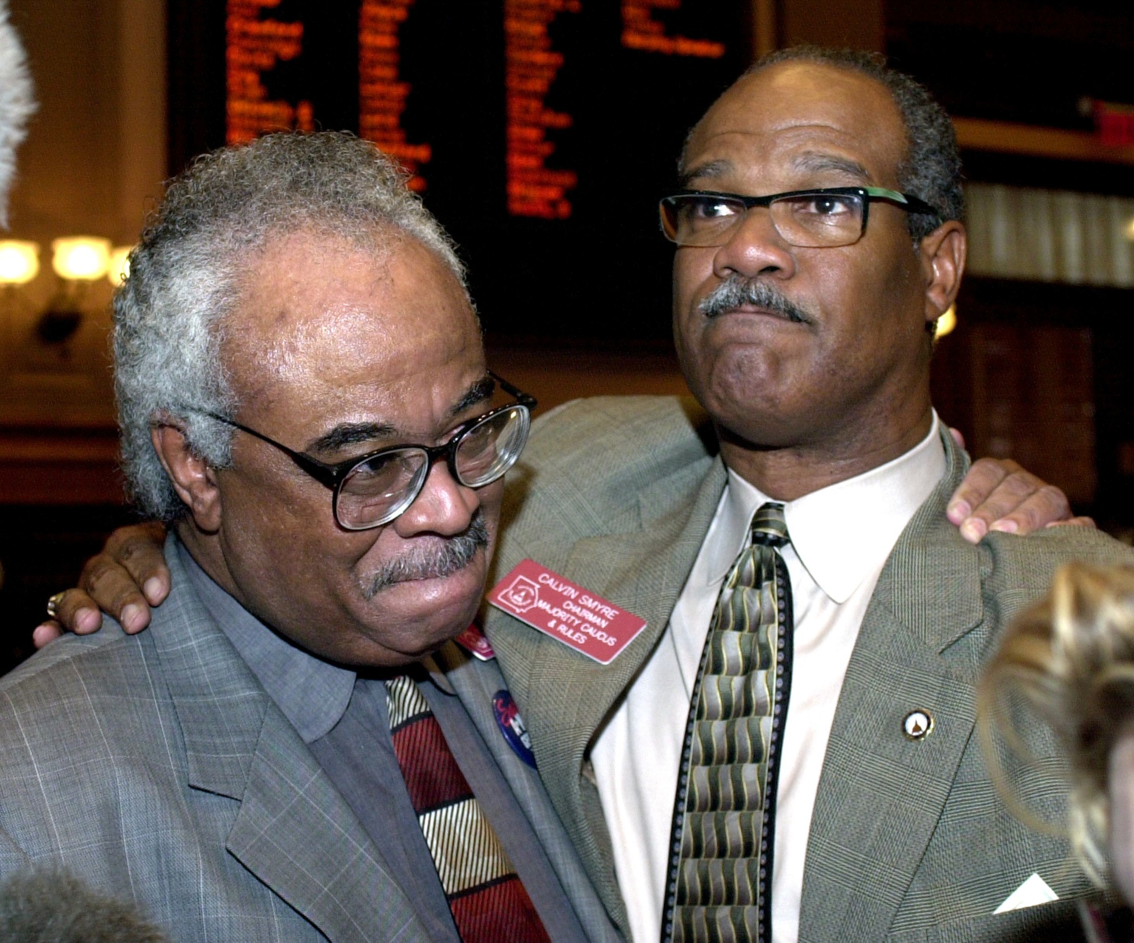Representatives Tyrone Brooks (left) and Calvin Smyre embrace after the Georgia House of Representatives voted in January 2001 to change the Georgia state flag. But a new battle over the flag was actually just beginning.