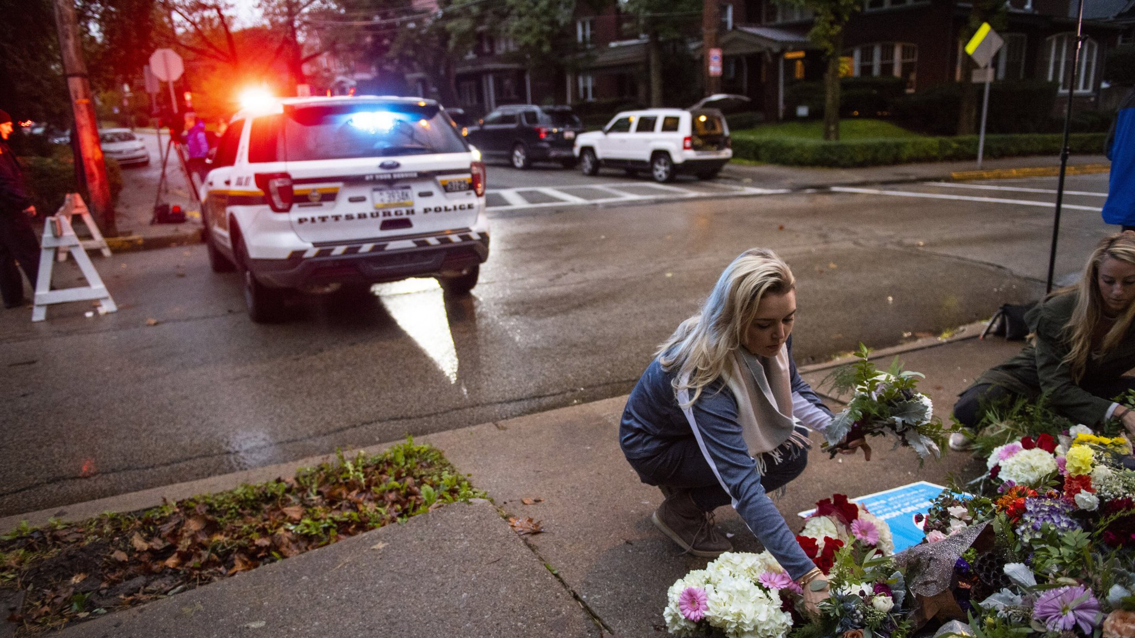 People place flowers near the Tree of Life Congregation, a day after 11 people died at the synagogue during a shooting rampage in Pittsburgh, Oct. 28, 2018. Georgia is one of 4 states without a hate crimes law. (Michael Henninger/The New York Times)