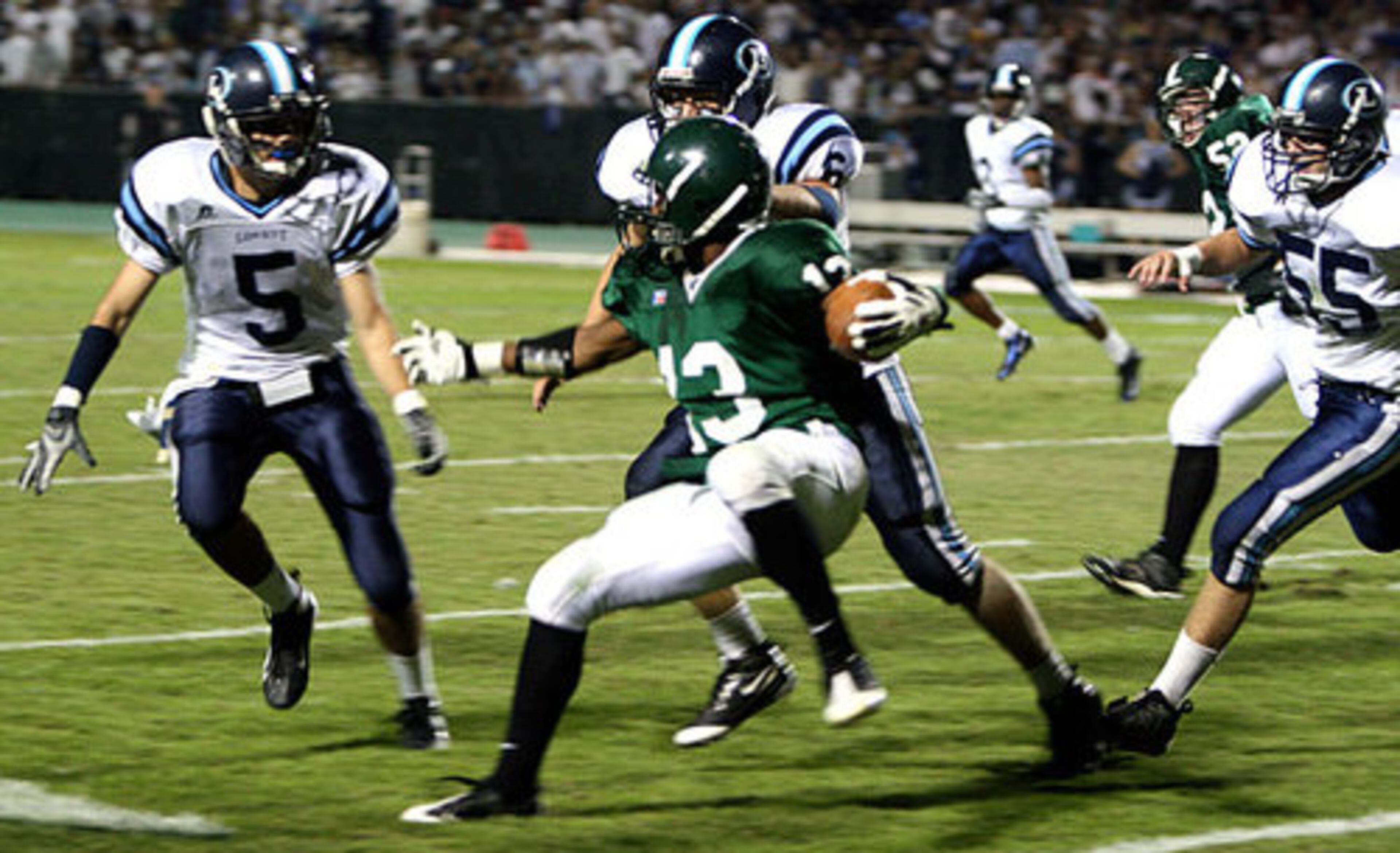 Lovett's Daniel Candler (5), Eric Hood (6) and Jack Rogers (55) surround Westminster's running back Stephon Shelton. The Lion's defense kept the Wildcats scoreless through the first quarter.