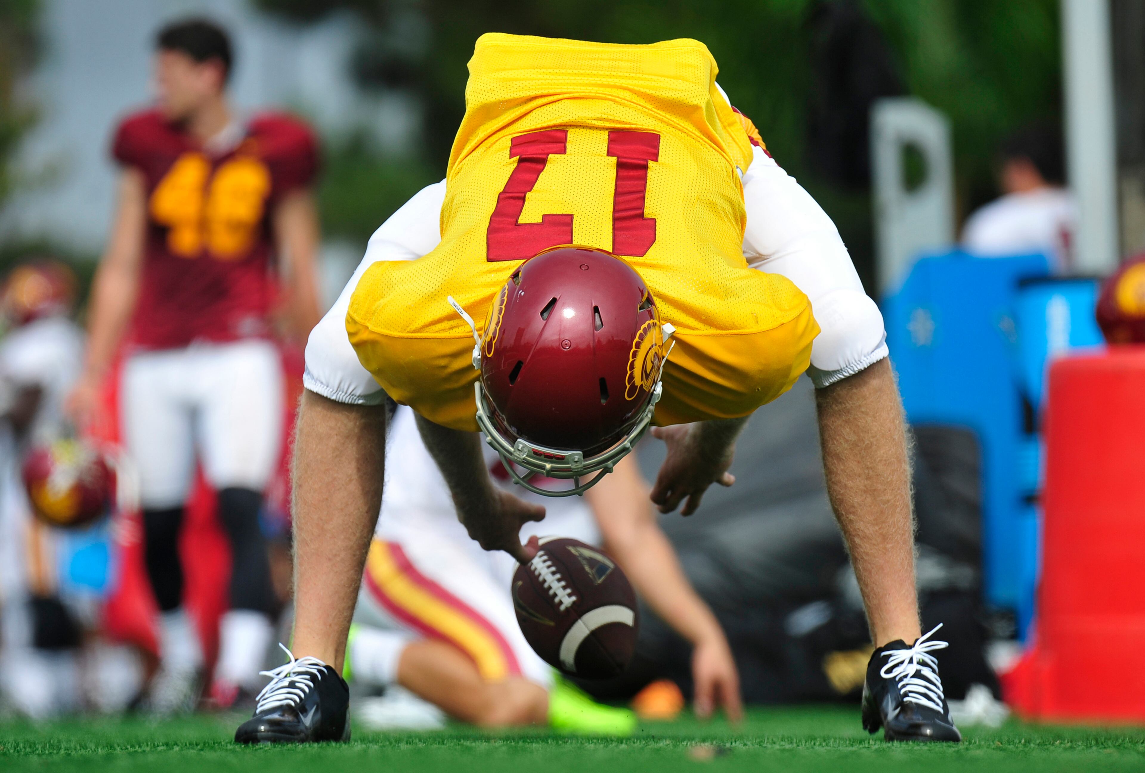 This photo provided by the University of Southern California shows USC football player Jake Olson snaping the ball during NCAA college football practice on Tuesday, Sept. 15, 2015 in Los Angeles. Olson who completely lost his sight six years ago still has a dream of playing football at Southern California. The blind long-snapper is one step closer to the Coliseum after practicing with the Trojans on Tuesday. (John McGillen/USCTrojans.com via AP)