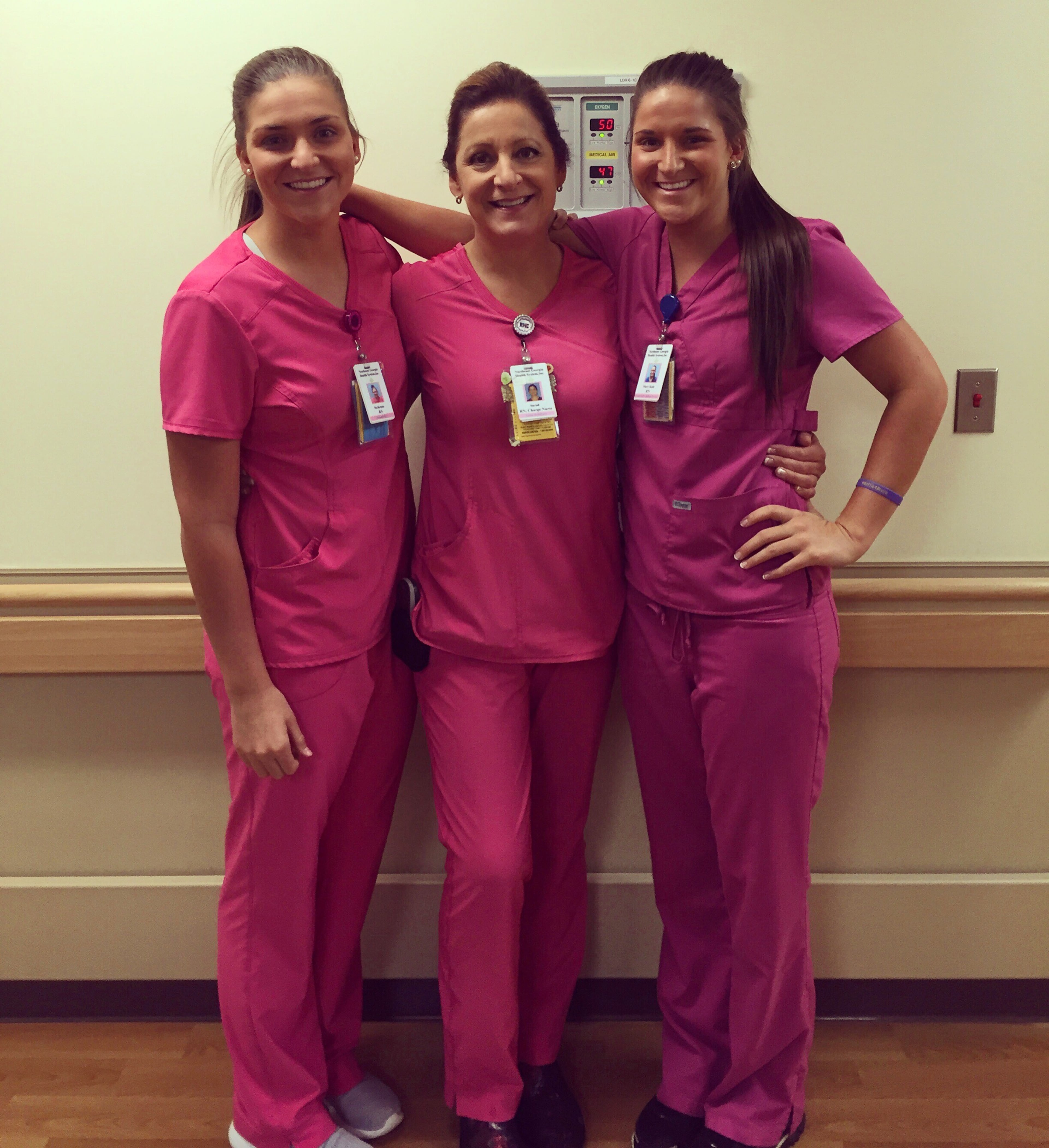 Twins Mckenna Roberts (far left) and Mary Kate Harris (far right) pose with their mother and fellow nurse Sarah Rushton at Northeast Georgia Medical Center in Gainesville. The three share a passion for helping others, especially babies. (Courtesy of Georgia Medical Center)