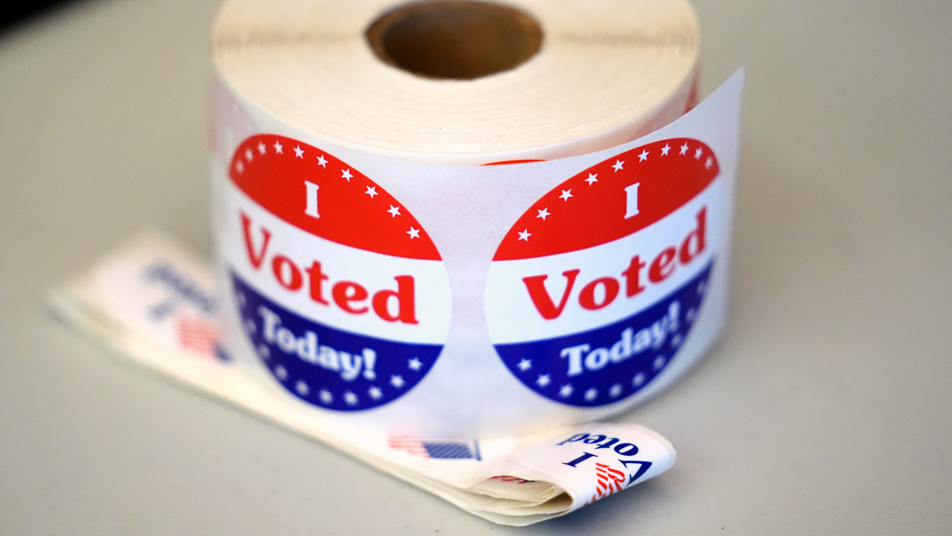 FILE - A spool of stickers rests on a table at a polling station during Massachusetts state primary voting, Sept. 3, 2024, at the Newton Free Library, in Newton, Mass. (AP Photo/Steven Senne, File)