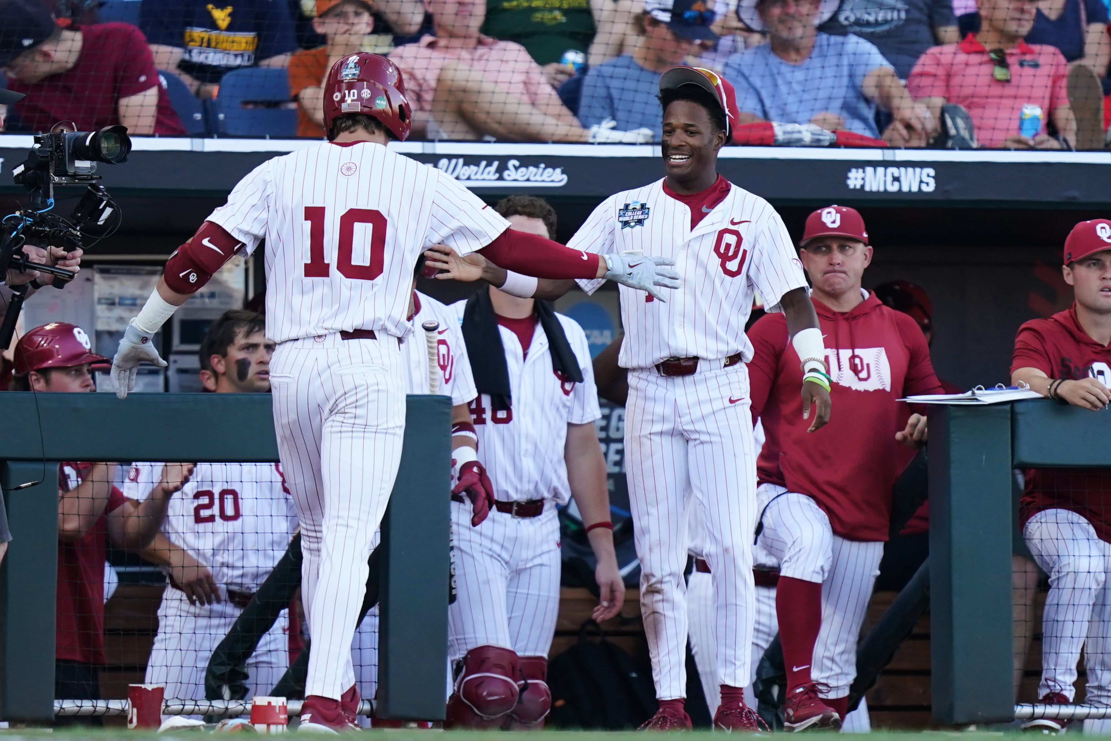 Oklahoma outfielder Jason Walk (right) congratulates catcher Brendan Brock after hitting a homer during their College World Series game against Georgia on Monday, June 15, 2026, in Omaha, Neb. (Vera Nieuwenhuis/AP)
