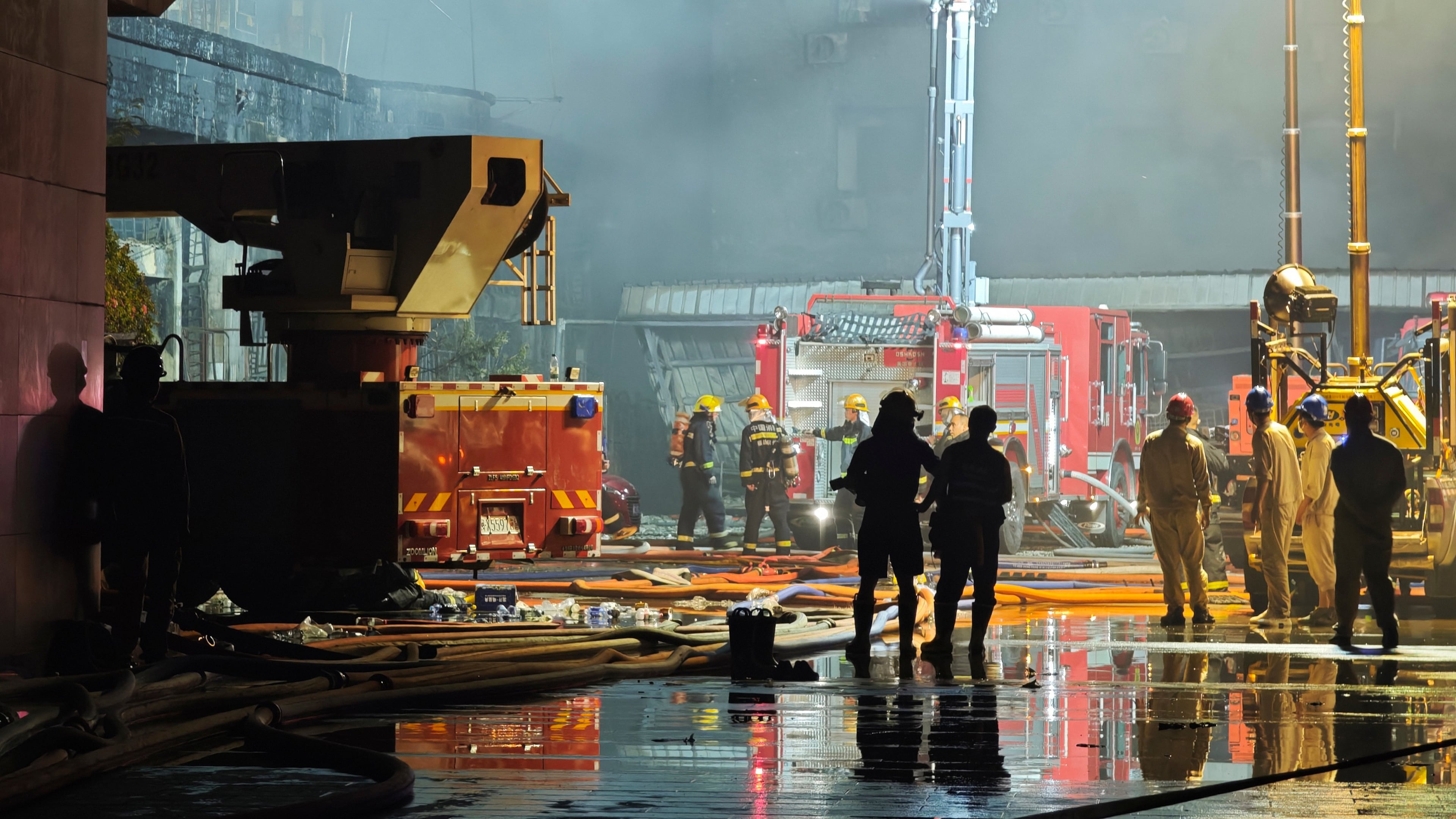 In this photo released by Xinhua News Agency, firefighters work at the scene of a footwear factory fire in Jiangtou village, Chendai township of Jinjiang city, southeastern China's Fujian province, on Thursday, July 9, 2026. (Zhou Yi/Xinhua News Agency via AP)