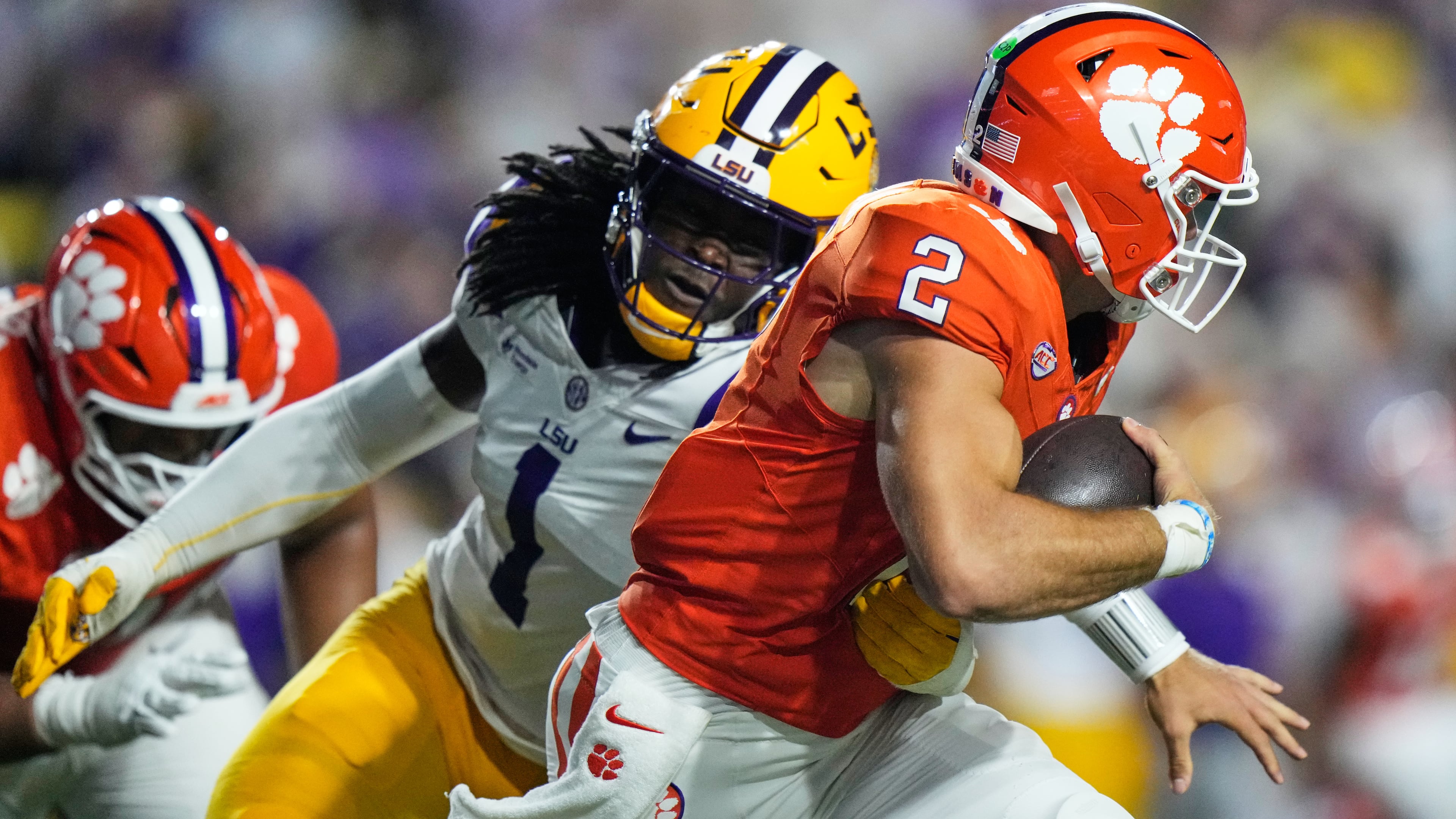 Clemson quarterback Tait Reynolds (2) is sacked by LSU defensive end Princewill Umanmielen (1) in the first half of an NCAA college football game, Saturday, Sept. 5, 2026 in Baton Rouge, La. (AP Photo/Gerald Herbert)