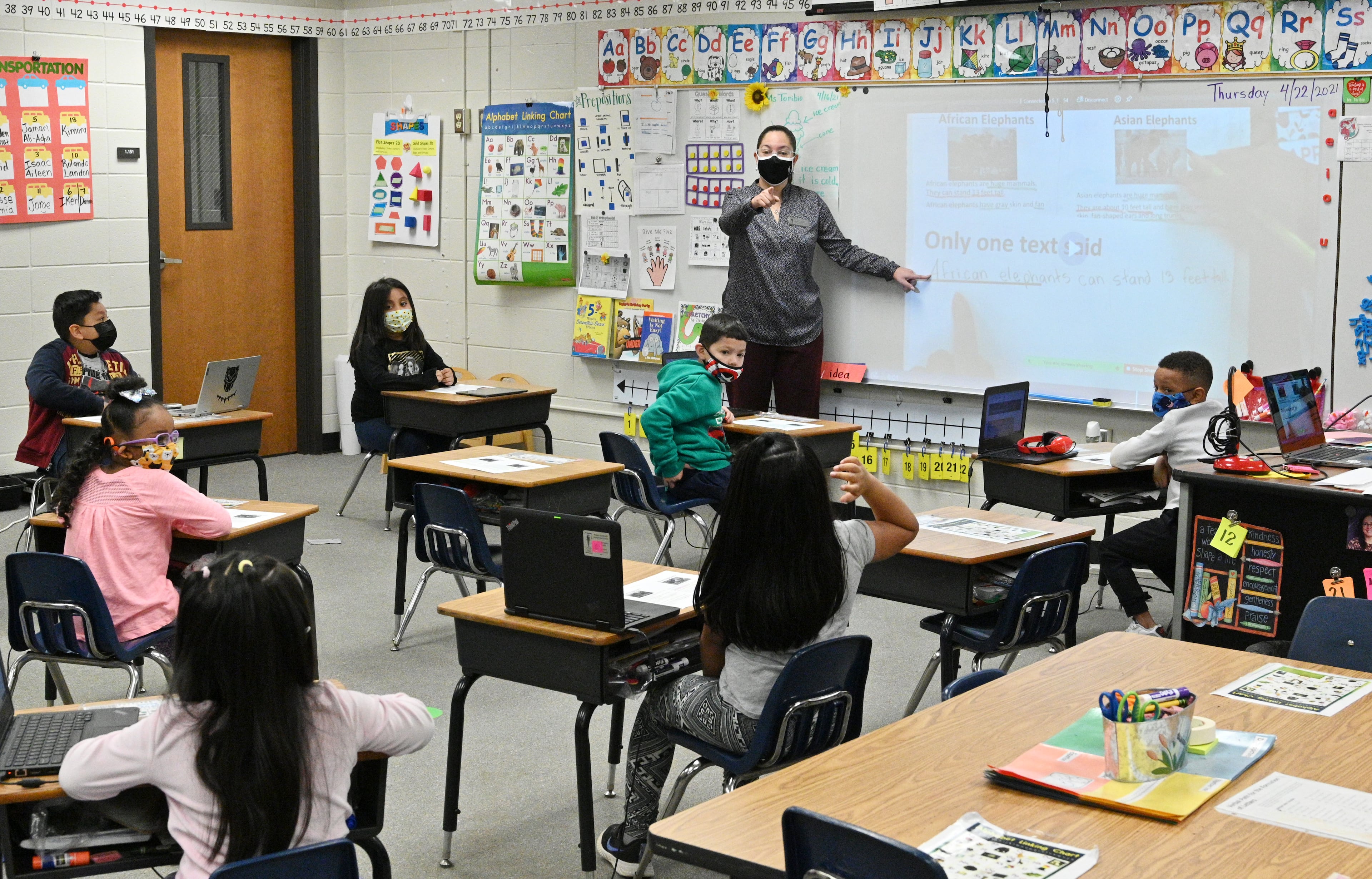 Lies Toribio, a first-year teacher who was once a custodian, teaches her kindergarten class at Bethesda Elementary in Lawrenceville on April 22, 2021. (Hyosub Shin / Hyosub.Shin@ajc.com)
