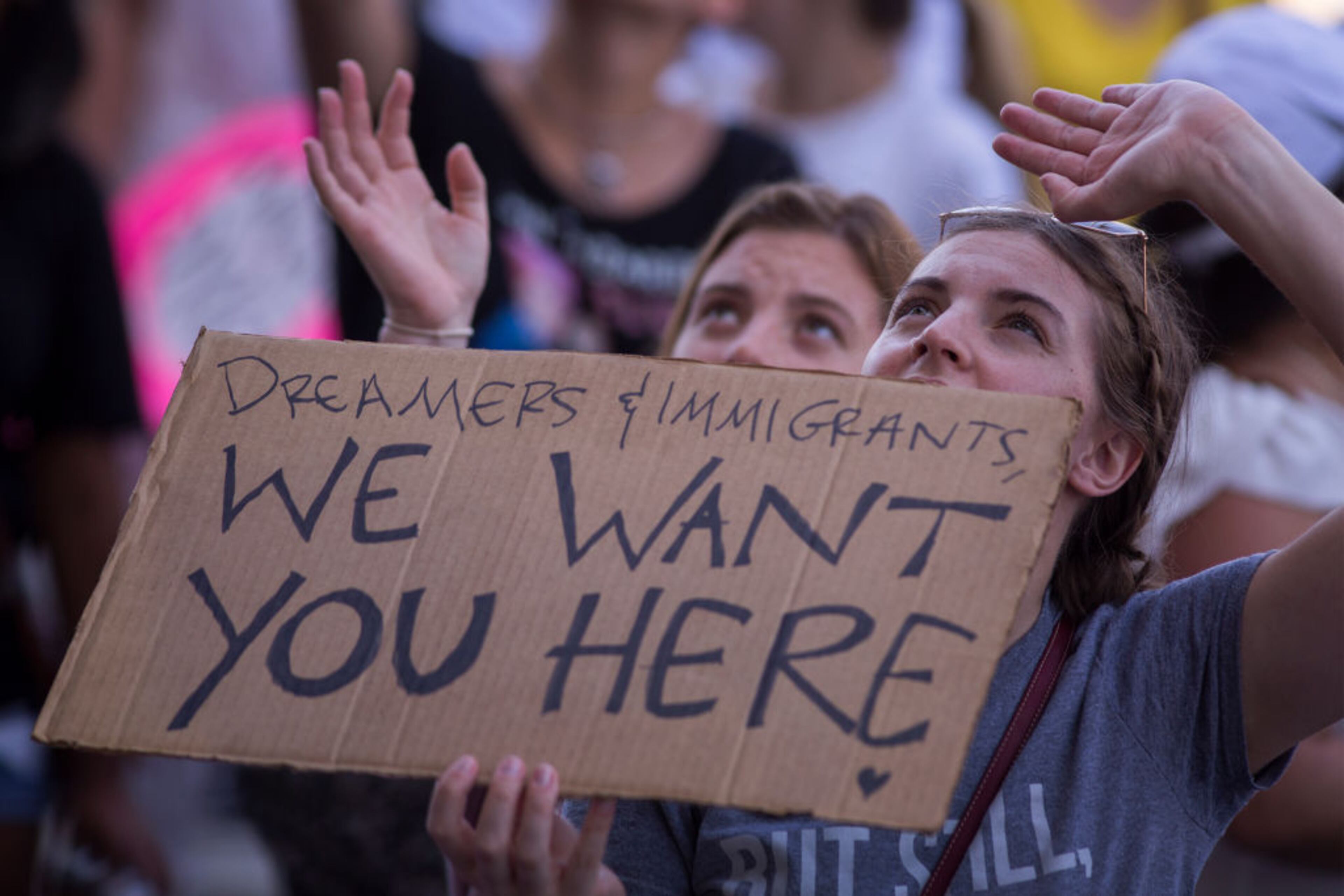 LOS ANGELES, CA - JUNE 30: People call words of encouragement up to people held inside the Metropolitan Detention Center after marching to decry Trump administration immigration and refugee policies on June 30, 2018 in Los Angeles, California. Although President Trump was forced to reverse his policy of removing all children from their immigrant or asylum-seeking parents, little clarity appears to be seen as to how agencies can fulfill a court order to reunite thousands of children and parents detained far apart by multiple agencies. Yesterday, the Justice Department filed papers in a Los Angeles federal court to have families arrested for illegal border crossings incarcerated together indefinitely. The rally is one of more than 700 such protests being held throughout the nation. (Photo by David McNew/Getty Images)